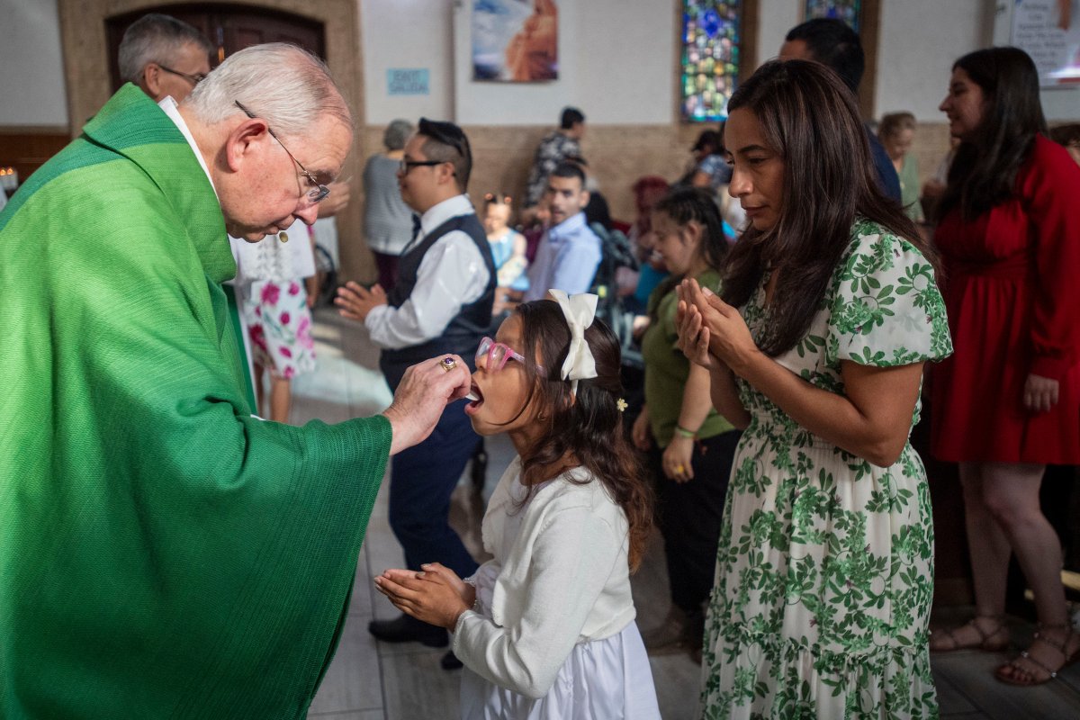 Archbishop José H. Gómez offers holy Communion during Fuerza Inc.'s 40th anniversary Mass for families of children with developmental disabilities at St. Matthias Church in Huntington Park on Oct. 18, 2026. (Michael Goulding)
