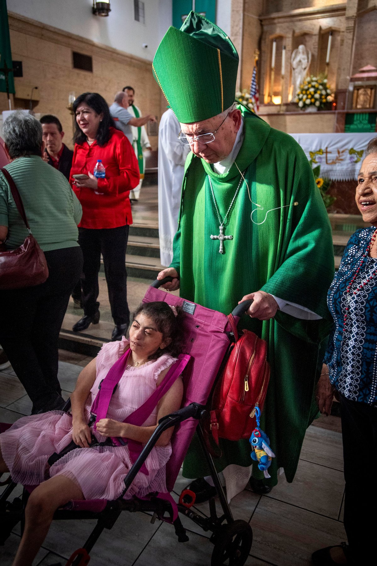 Archbishop José H. Gómez pushes a girl with developmental disabilities during Fuerza Inc.'s 40th anniversary Mass at St. Matthias Church in Huntington Park on Oct. 18, 2026. (Michael Goulding)