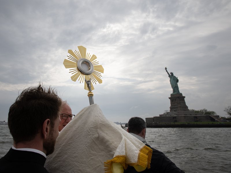 Cardinal Timothy Dolan Carries the Blessed Sacrament to Liberty Island by Boat as Part of the National Eucharistic Pilgrimage