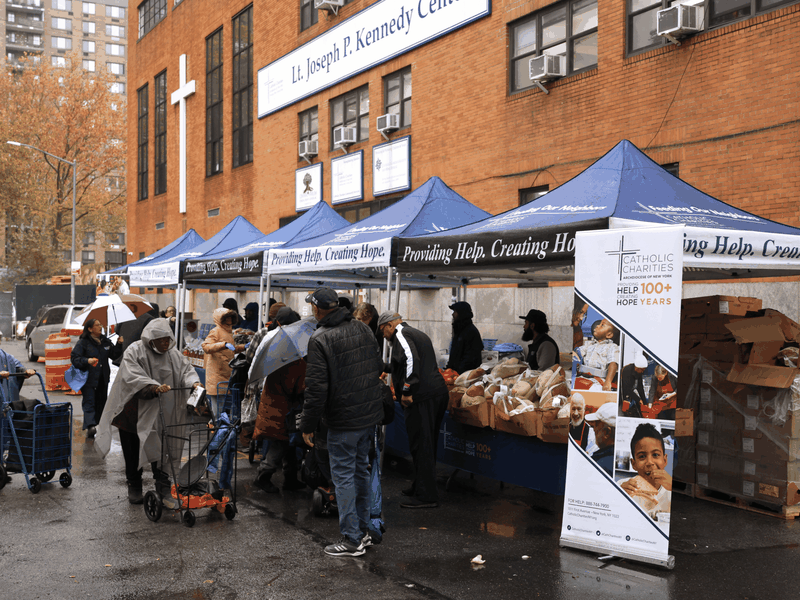 Catholic Charities Volunteers and Clients Brave the Rain for Turkey Distribution at Kennedy Center