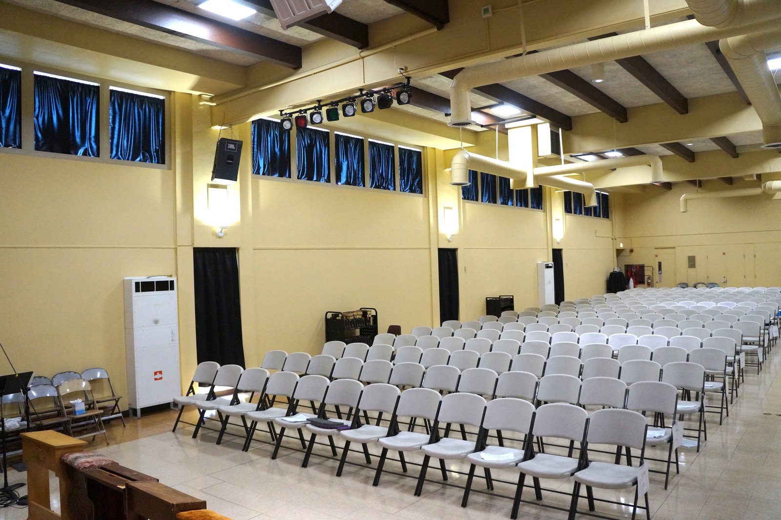 The renovated hall at Holy Innocents School in Long Beach shows new paint, lighting, sound system and air conditioning after vandals desecrated the space on Feb. 2, 2026.