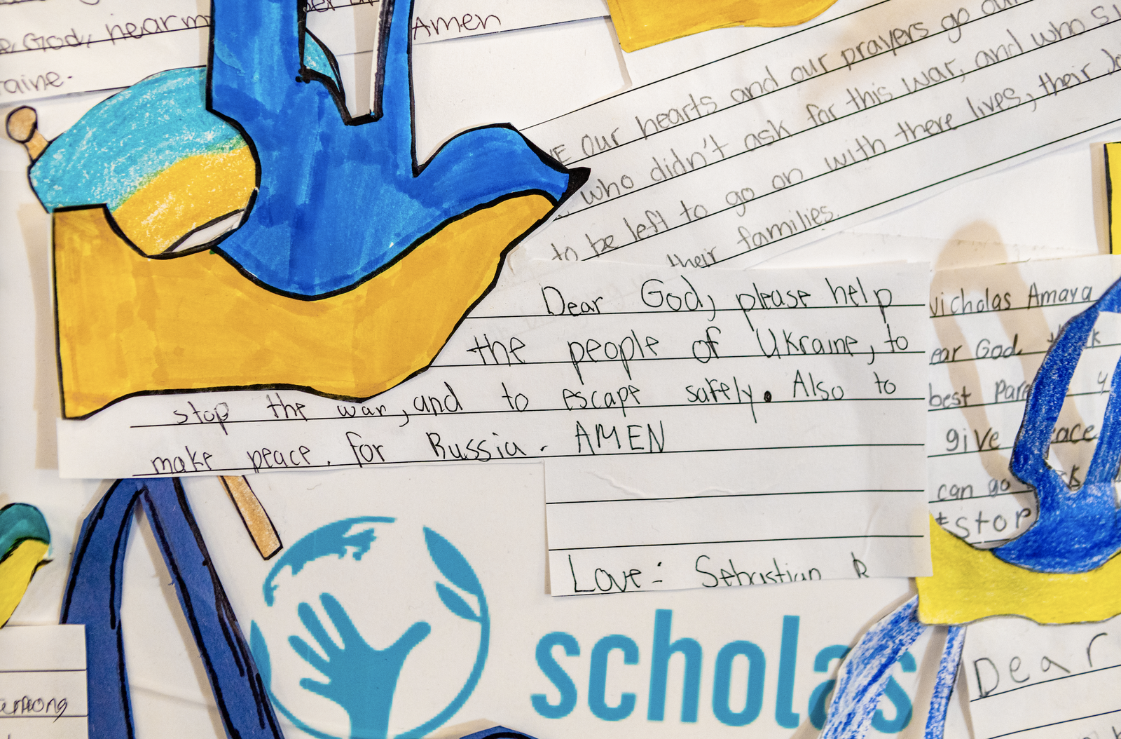 Christ the King students were invited to share prayerrs on a special mural they created and presented at Mass March 25. (Ron Echual)