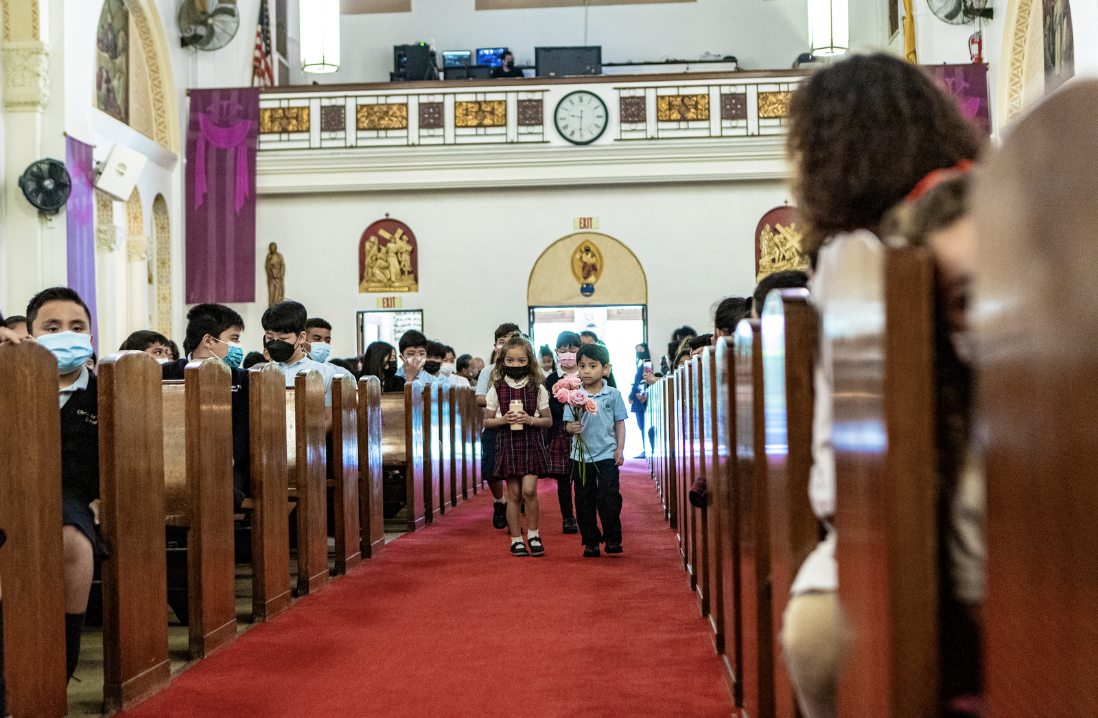 Christ the King students brought flowers to Mary during a prayer service following Mass. (Ron Echual)