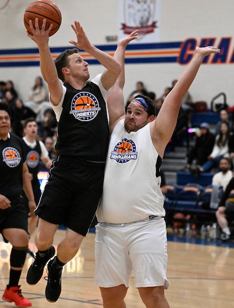 Father Michael Masteller goes up against Seminarians’ Tommy Green in the annual basketball game, Feb. 17, 2023. (John McCoy)