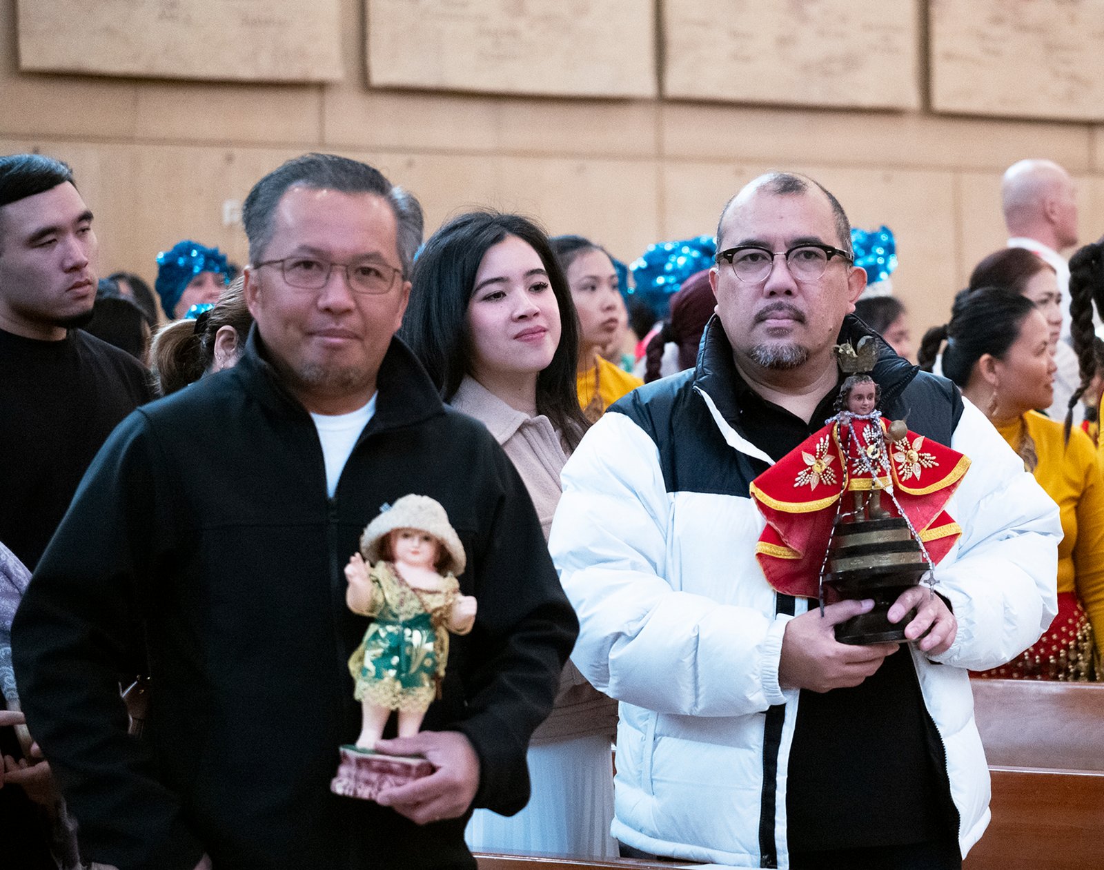 Churchgoers at the Feast of Santo Niño Mass hold up their statues to be blessed during the event at the Cathedral of Our Lady of the Angels on Jan. 21. (Victor Alemán)