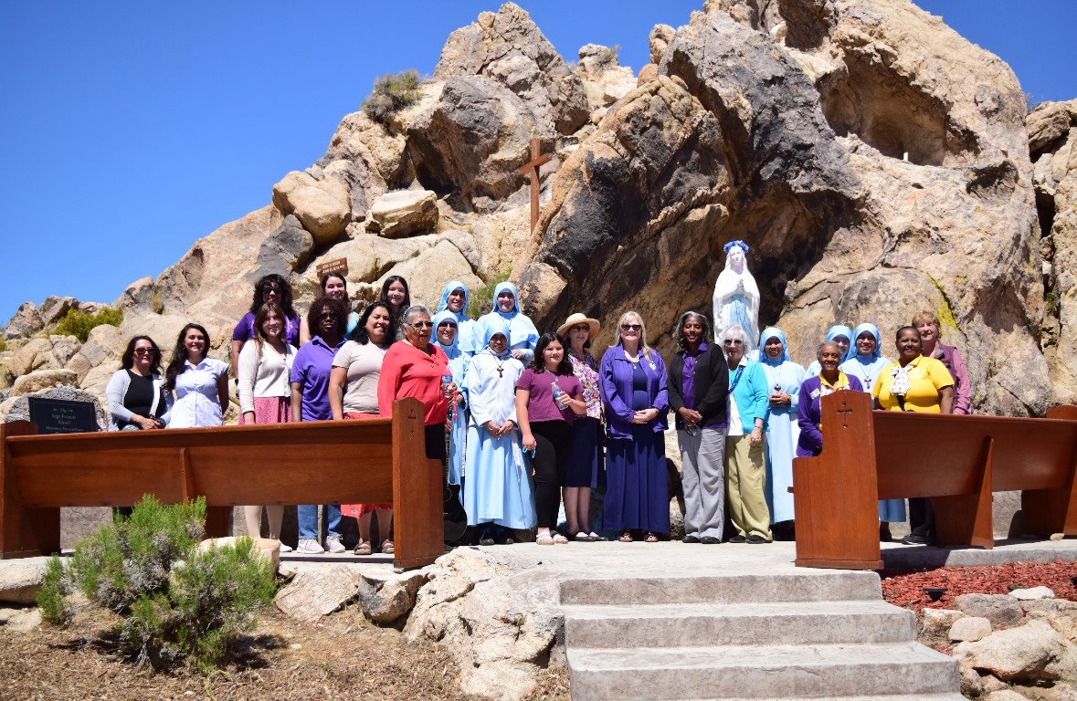Parishioners and members of Catholic Daughters and Junior Catholic Daughters with Sacred Heart Church in Lancaster pose during a May Crowning event on May 11 at Lake Los Angeles. (Angie Paliza)
