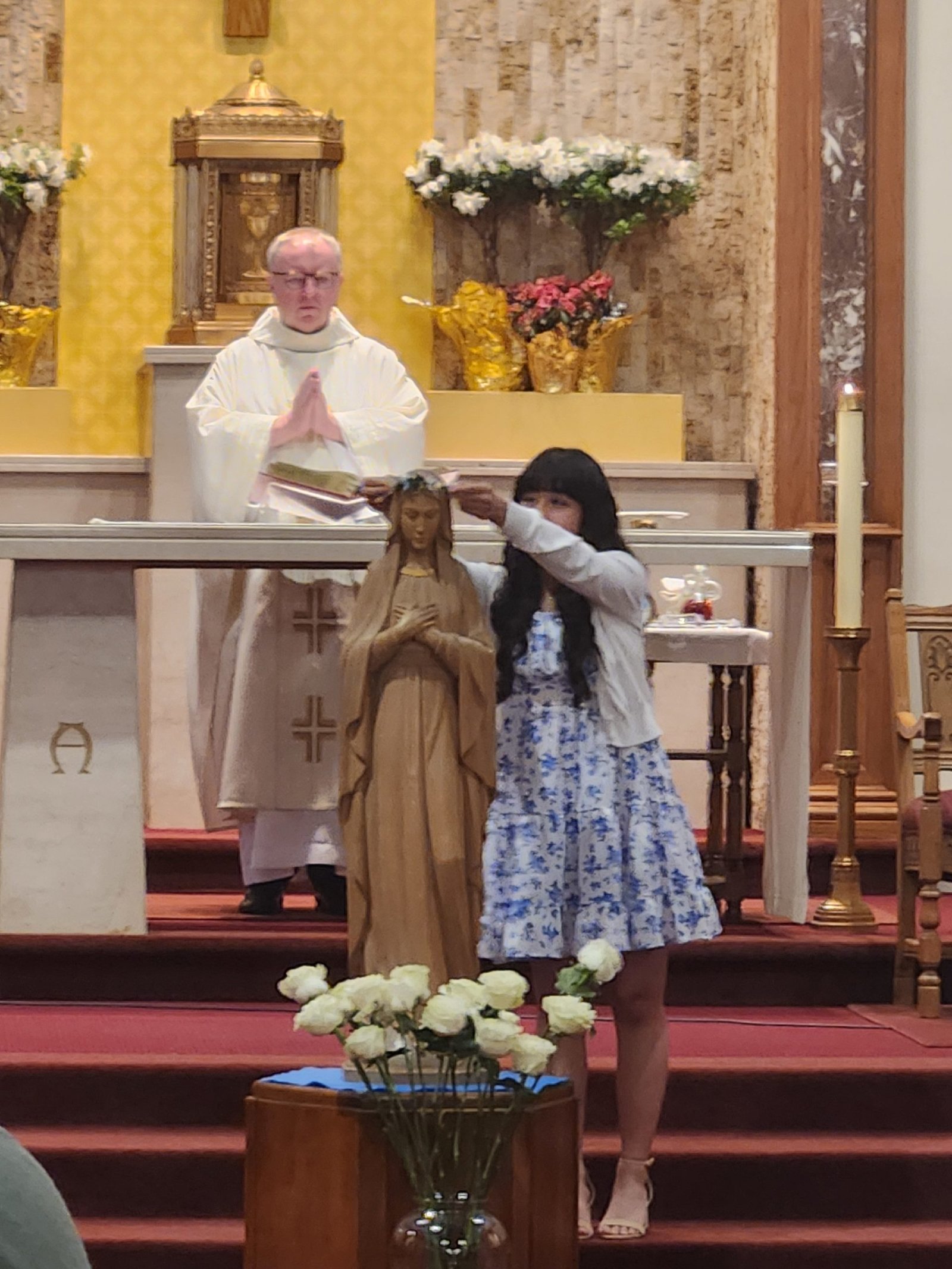 Student Victoria Kaspar crowns Mary during a May Crowning event at Saints Felicitas and Perpetua Church in San Marino. (Noreen Maricich)