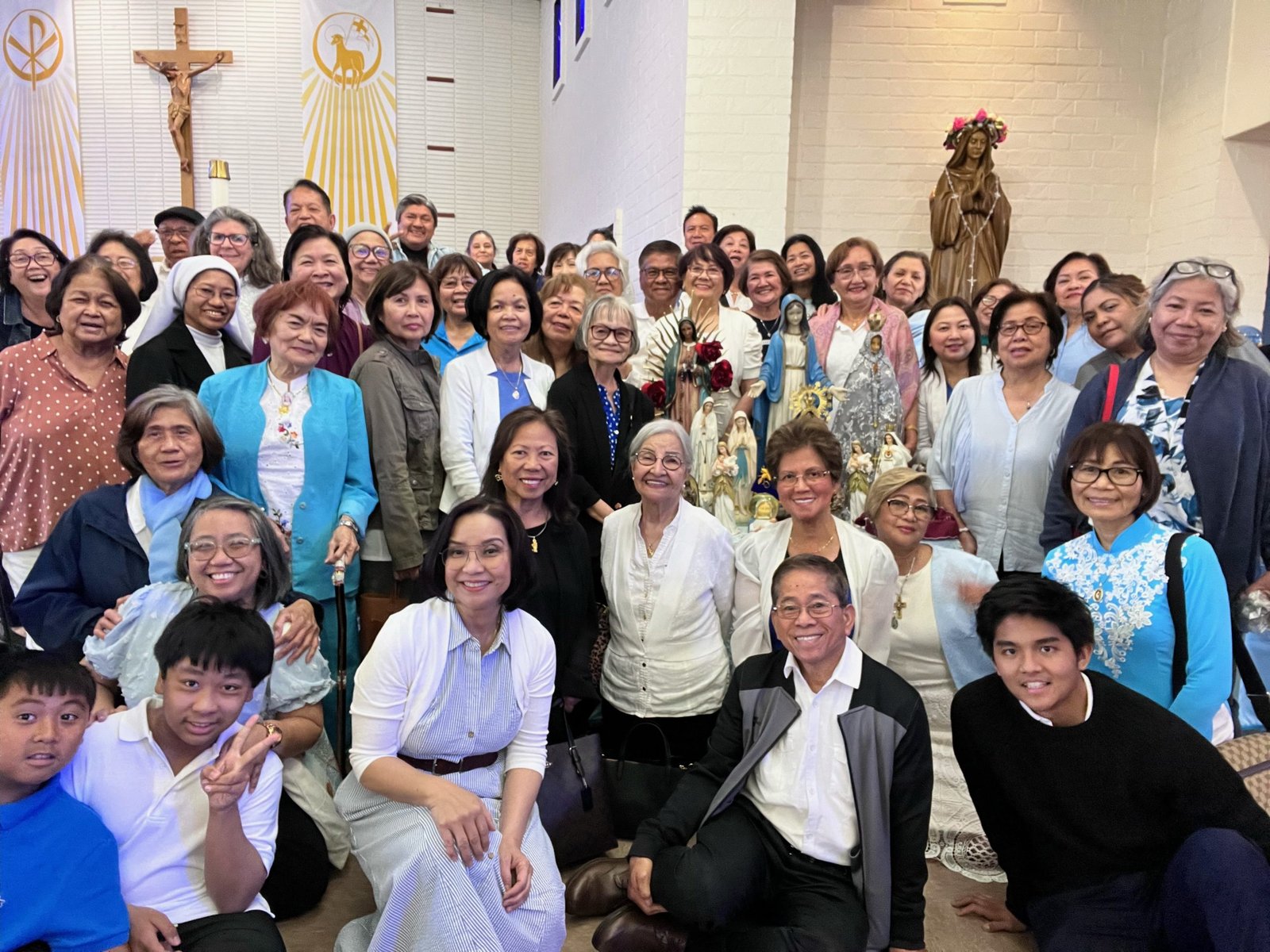 Parishioners at St. Pancratius Church in Lakewood pose with the crowned Mary statue during a May Crowning event at the parish on May 5. (St. Pancratius Church)