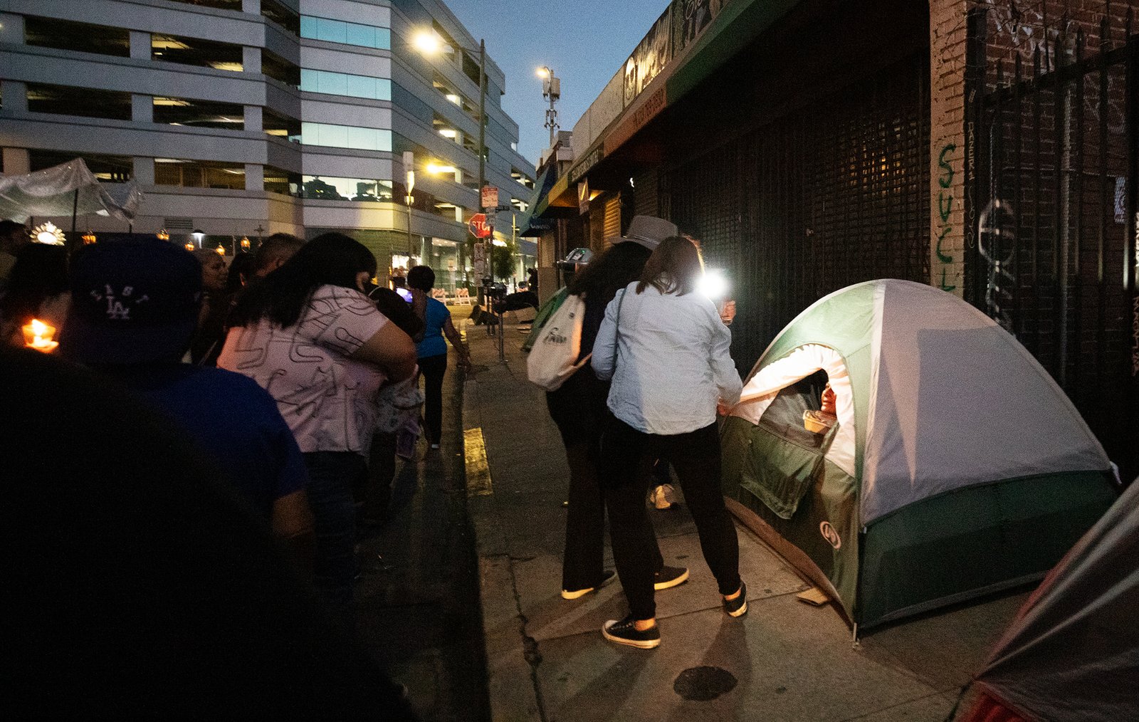 People stop to pray and assist the homeless on Skid Row during a Eucharistic procession on the evening of July 27 put on by the Archdiocese of Los Angeles’ Office for Vocations and the Friars and Sisters of the Poor of Jesus Christ LA. (Victor Alemán)