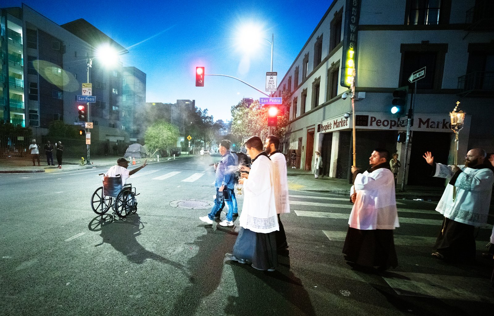 A man reacts during a Eucharistic Procession through downtown LA’s Skid Row on Saturday, July 27. (Victor Alemán)