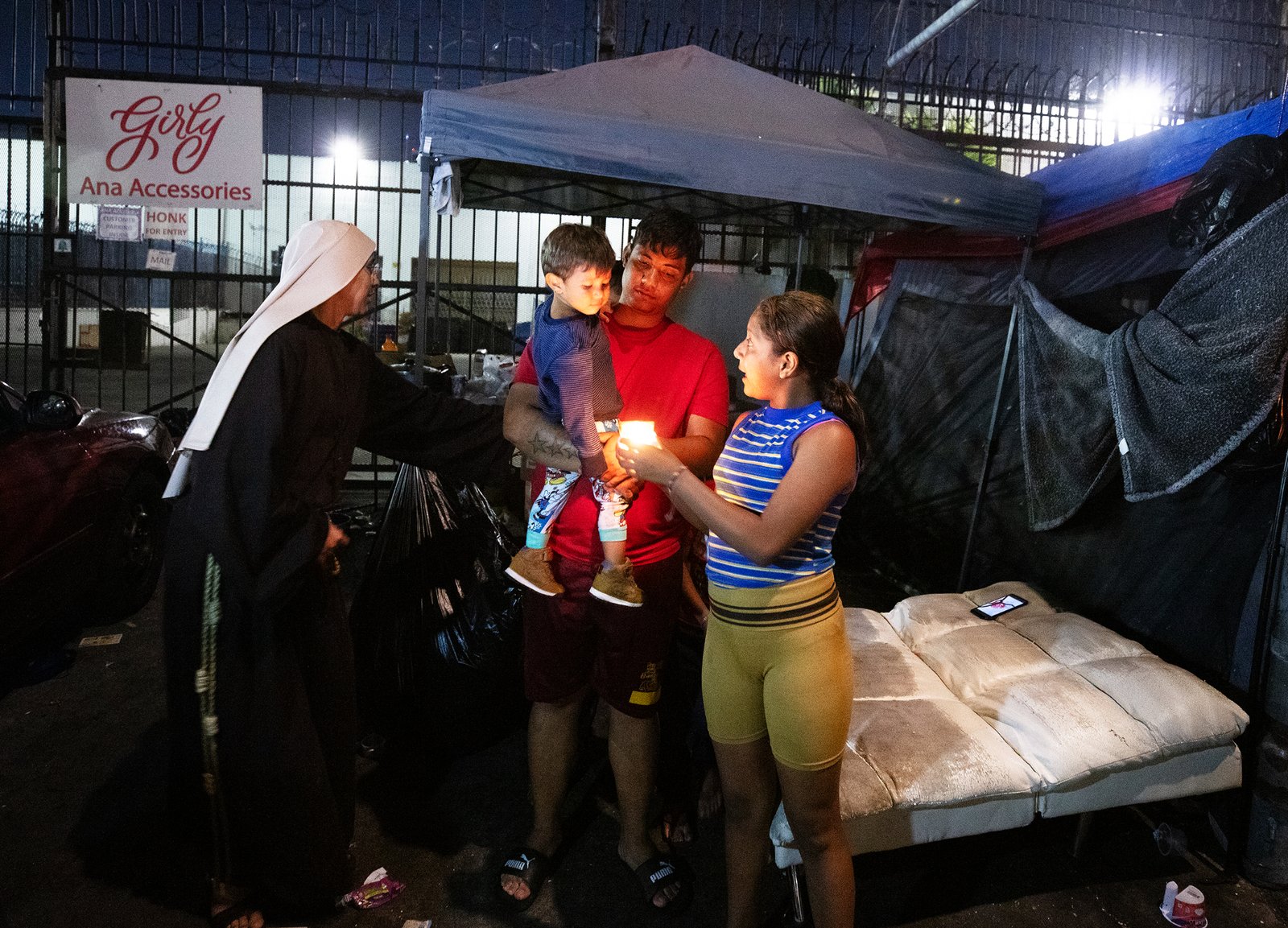 People stop to pray and assist the homeless on Skid Row during a Eucharistic procession on the evening of July 27 put on by the Archdiocese of Los Angeles’ Office for Vocations and the Friars and Sisters of the Poor of Jesus Christ LA. (Victor Alemán)