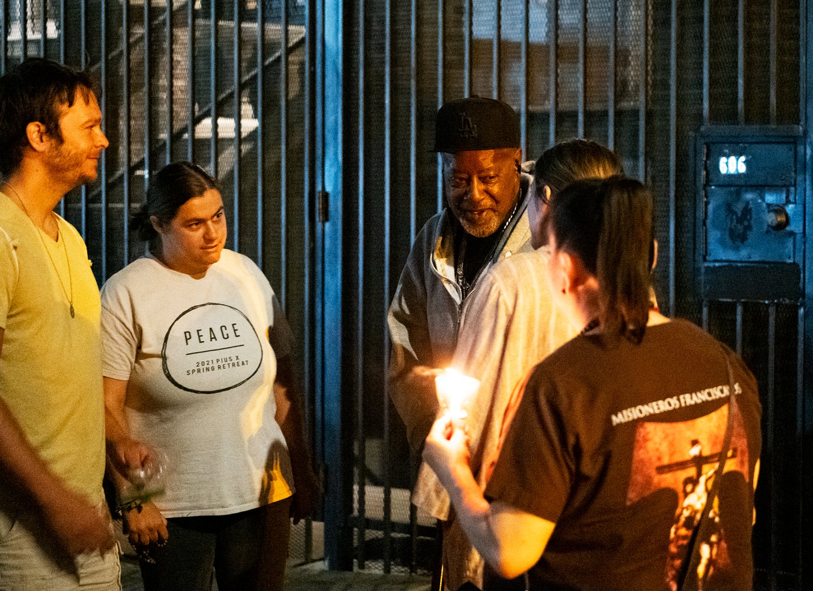 People stop to pray and assist the homeless on Skid Row during a Eucharistic procession on the evening of July 27 put on by the Archdiocese of Los Angeles’ Office for Vocations and the Friars and Sisters of the Poor of Jesus Christ LA. (Victor Alemán)