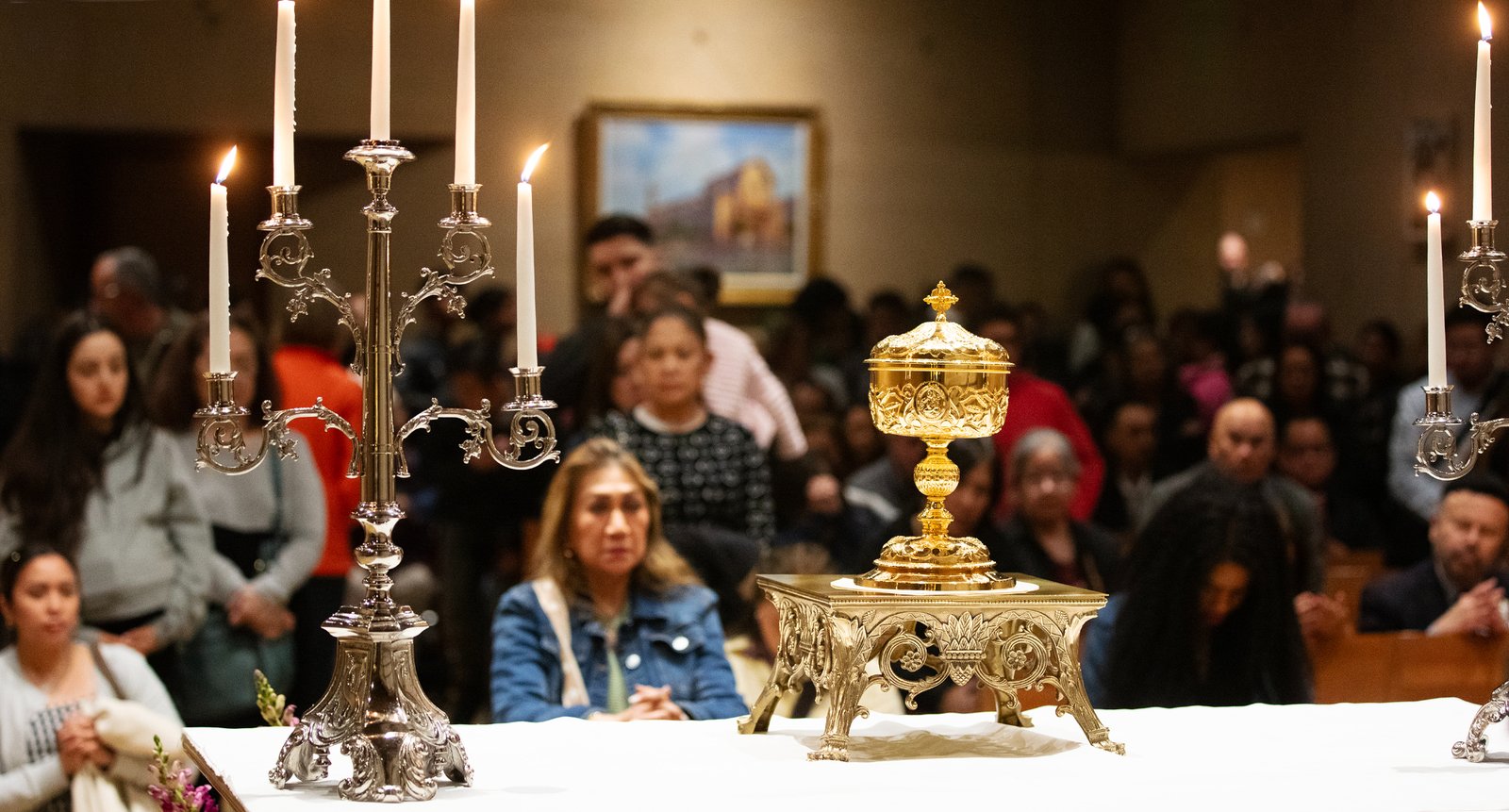 Parishioners kneel in front of the Eucharist at the Cathedral of Our Lady of the Angels on Holy Thursday, April 17. (Victor Alemán)
