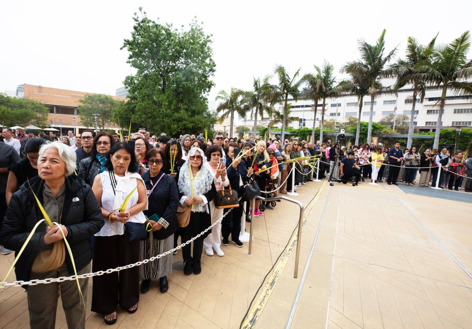 Parishioners gather in the outdoor plaza at the Cathedral of Our Lady of the Angels before the Palm Sunday Mass on April 13. (Victor Alemán)