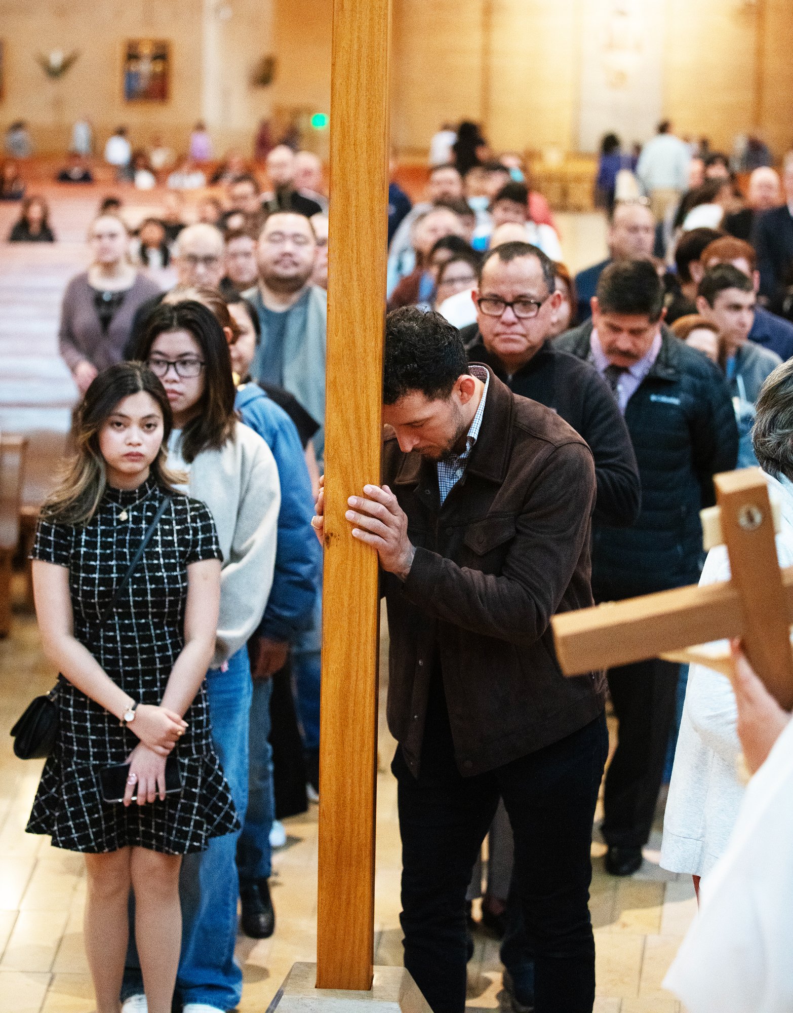Attendees venerate in front of the cross during a Good Friday liturgy at the Cathedral of Our Lady of the Angels on April 18. (Victor Alemán)