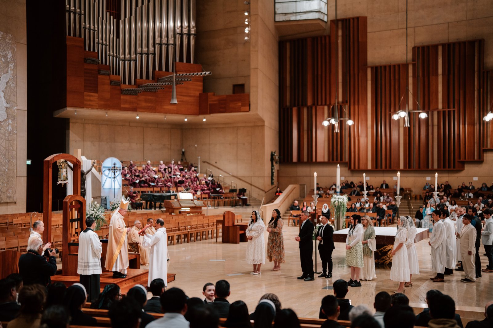 Candidates ready to enter fully into the Catholic Church stand at the Cathedral of Our Lady of the Angels during the Easter Vigil Mass on April 19. (Peter Lobato)