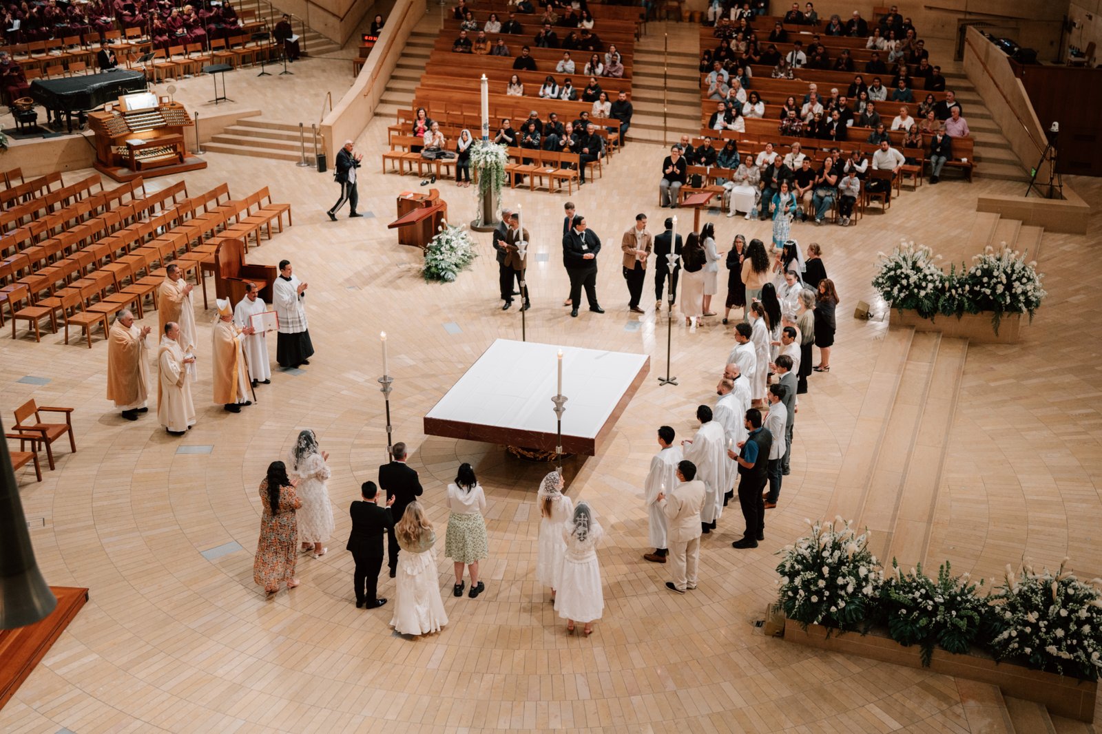 Candidates ready to enter fully into the Catholic Church stand at the Cathedral of Our Lady of the Angels during the Easter Vigil Mass on April 19. (Peter Lobato)