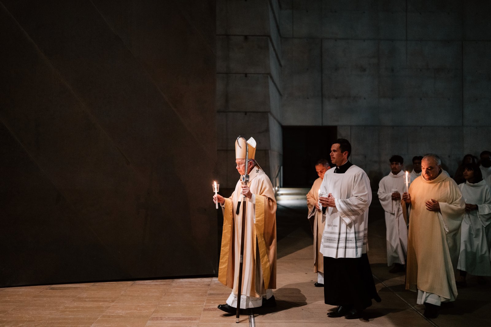 Archbishop José H. Gomez carries a candle while leading the faithful into the Cathedral of Our Lady of the Angels for the Easter Vigil Mass on April 19. (Peter Lobato)