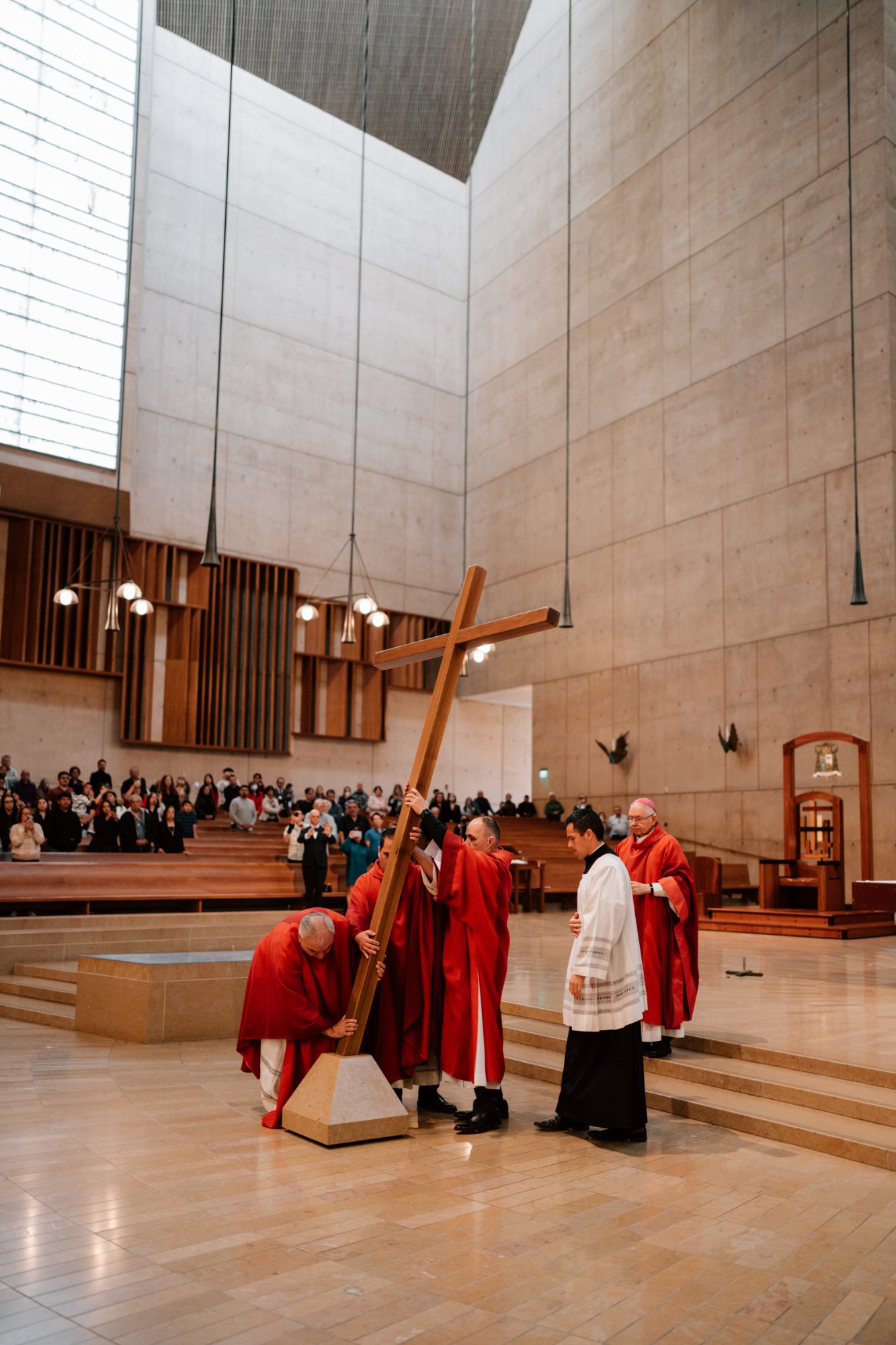 Archbishop José H. Gomez leads other priests in placing the cross during a Good Friday liturgy at the Cathedral of Our Lady of the Angels on April 18. (Peter Lobato)