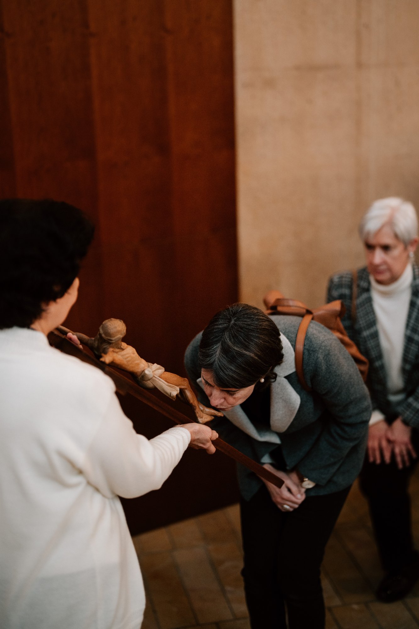 Attendees kiss and venerate in front of the cross during a Good Friday liturgy at the Cathedral of Our Lady of the Angels on April 18. (Peter Lobato)