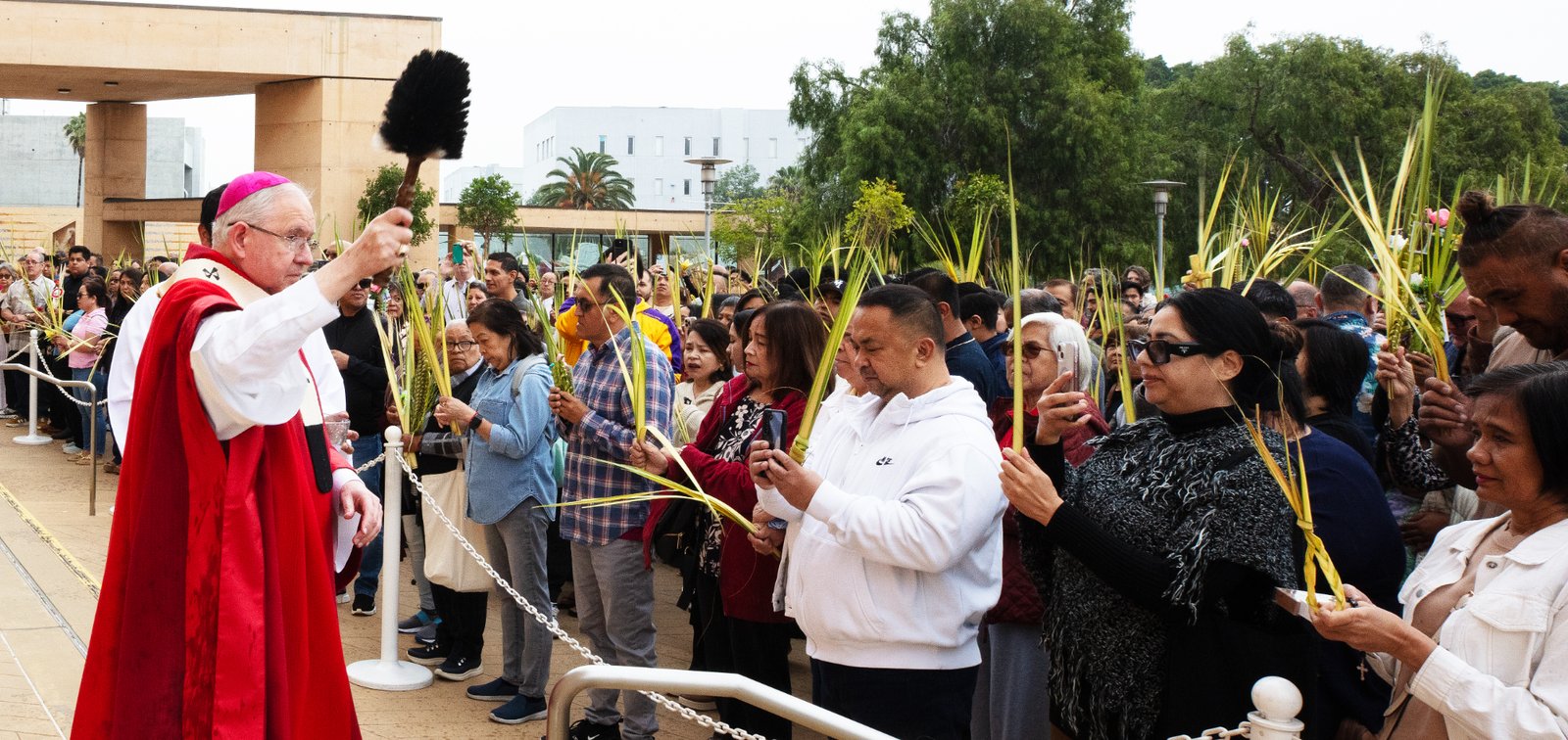 Archbishop José H. Gomez blesses parishioners gathered in the outdoor plaza at the Cathedral of Our Lady of the Angels before the Palm Sunday Mass on April 13. (Victor Alemán)