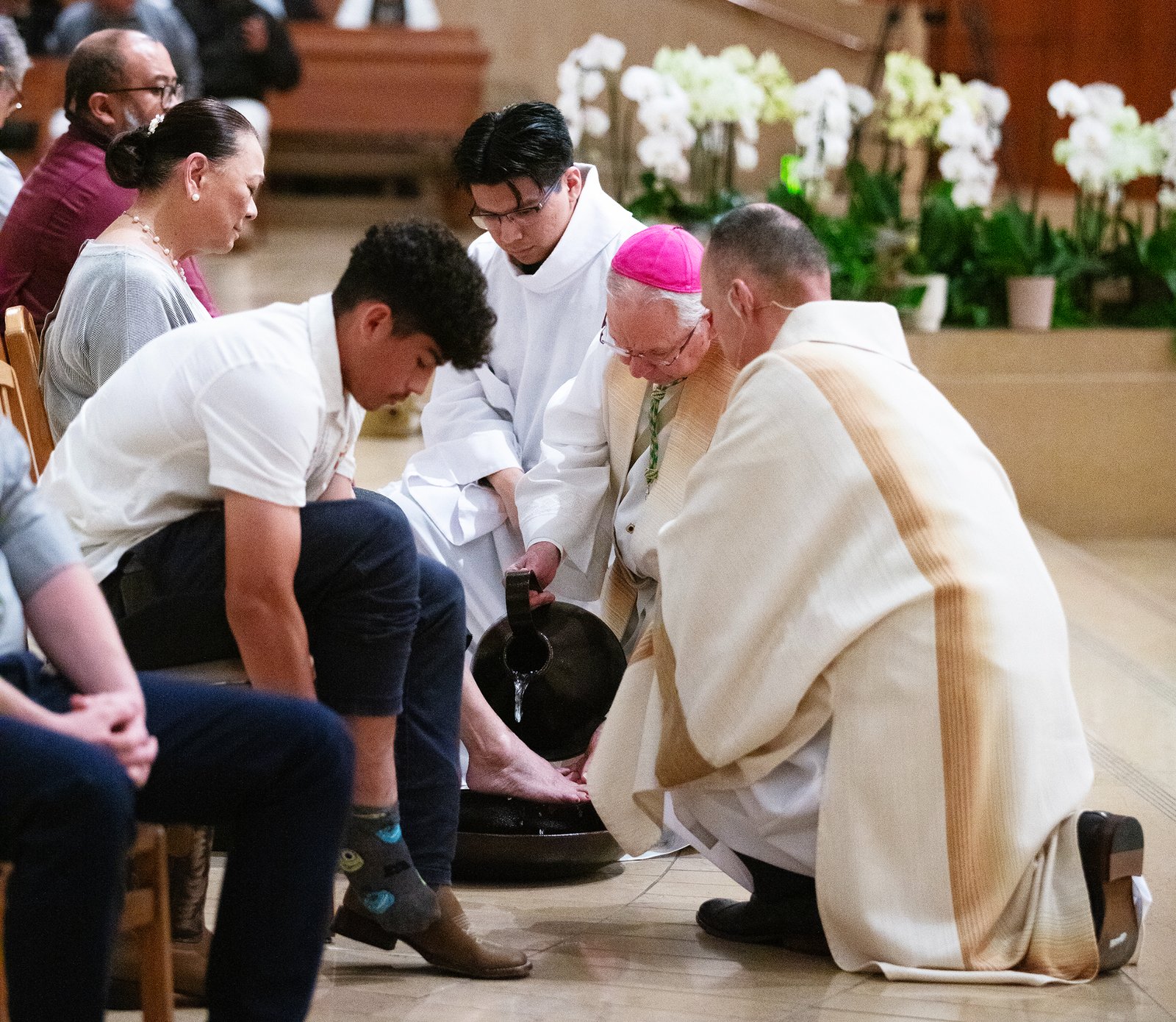 Archbishop José H. Gomez washes the feet of parishioners during the Mass of the Lord’s Supper at the Cathedral of Our Lady of the Angels on April 17. (Victor Alemán)