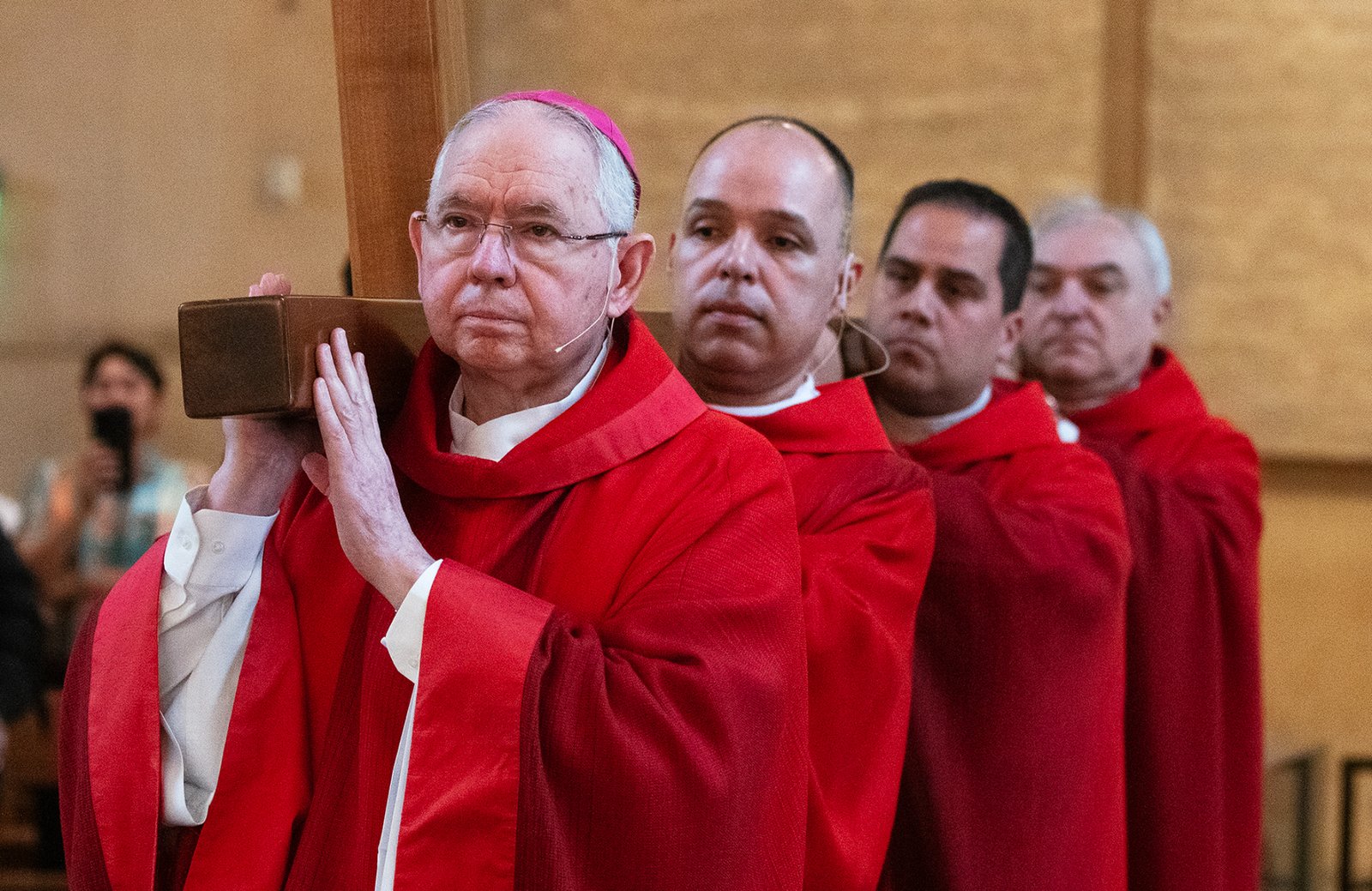 Archbishop José H. Gomez leads other priests in carrying the cross during a Good Friday liturgy at the Cathedral of Our Lady of the Angels on April 18. (Victor Alemán)