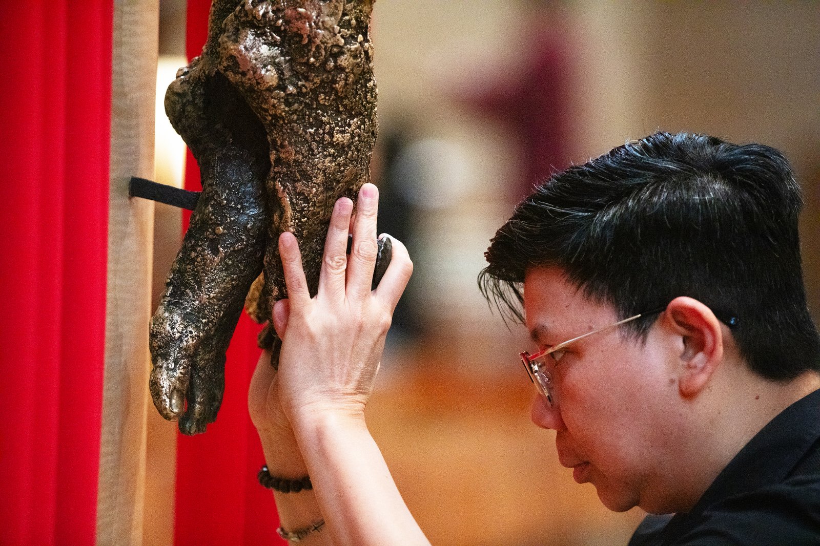 Attendees venerate in front of the cross during a Good Friday liturgy at the Cathedral of Our Lady of the Angels on April 18. (Victor Alemán)