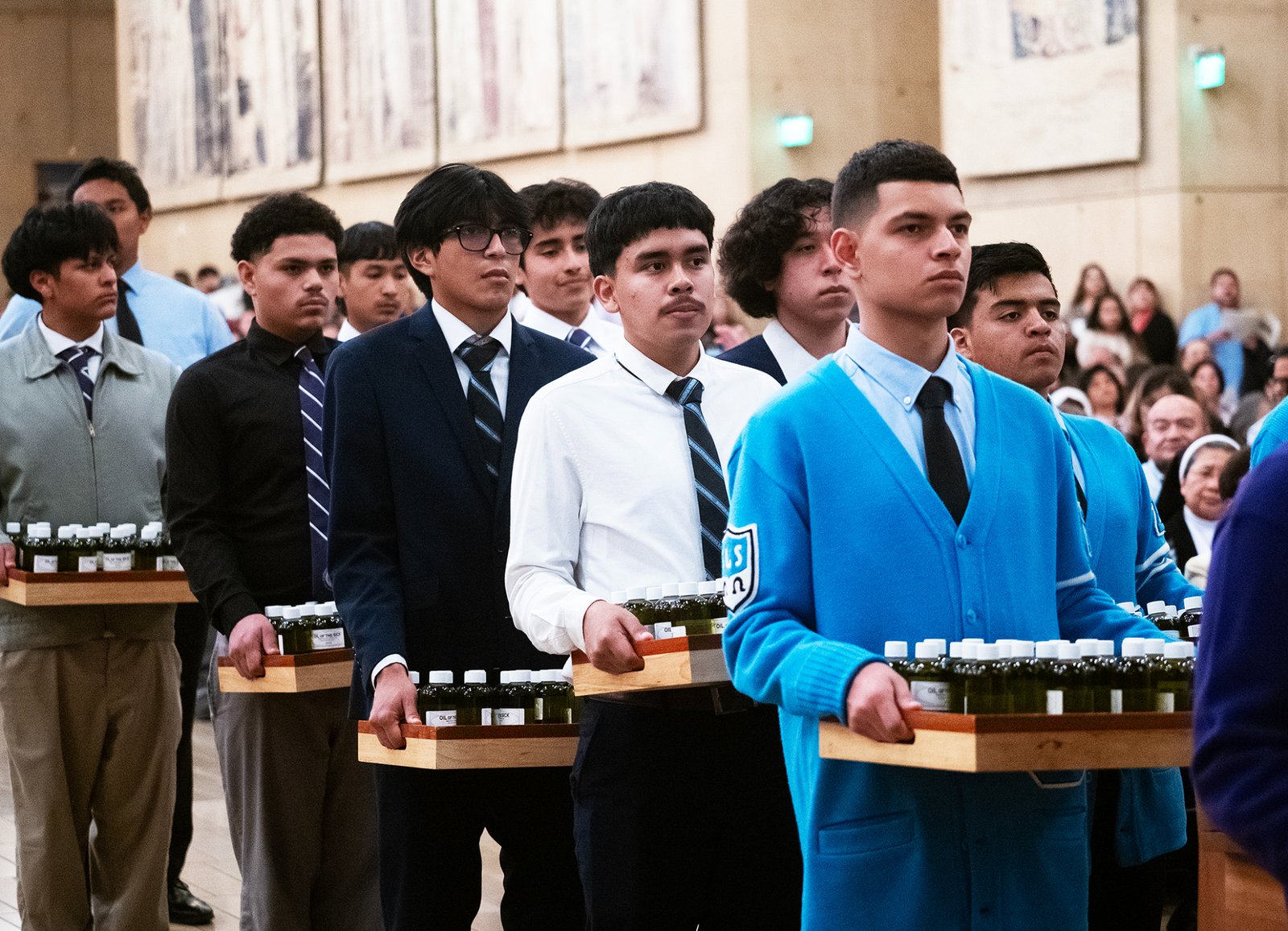Young people carry the oils to be blessed during the Chrism Mass at the Cathedral of Our Lady of the Angels on April 14. (Victor Alemán)