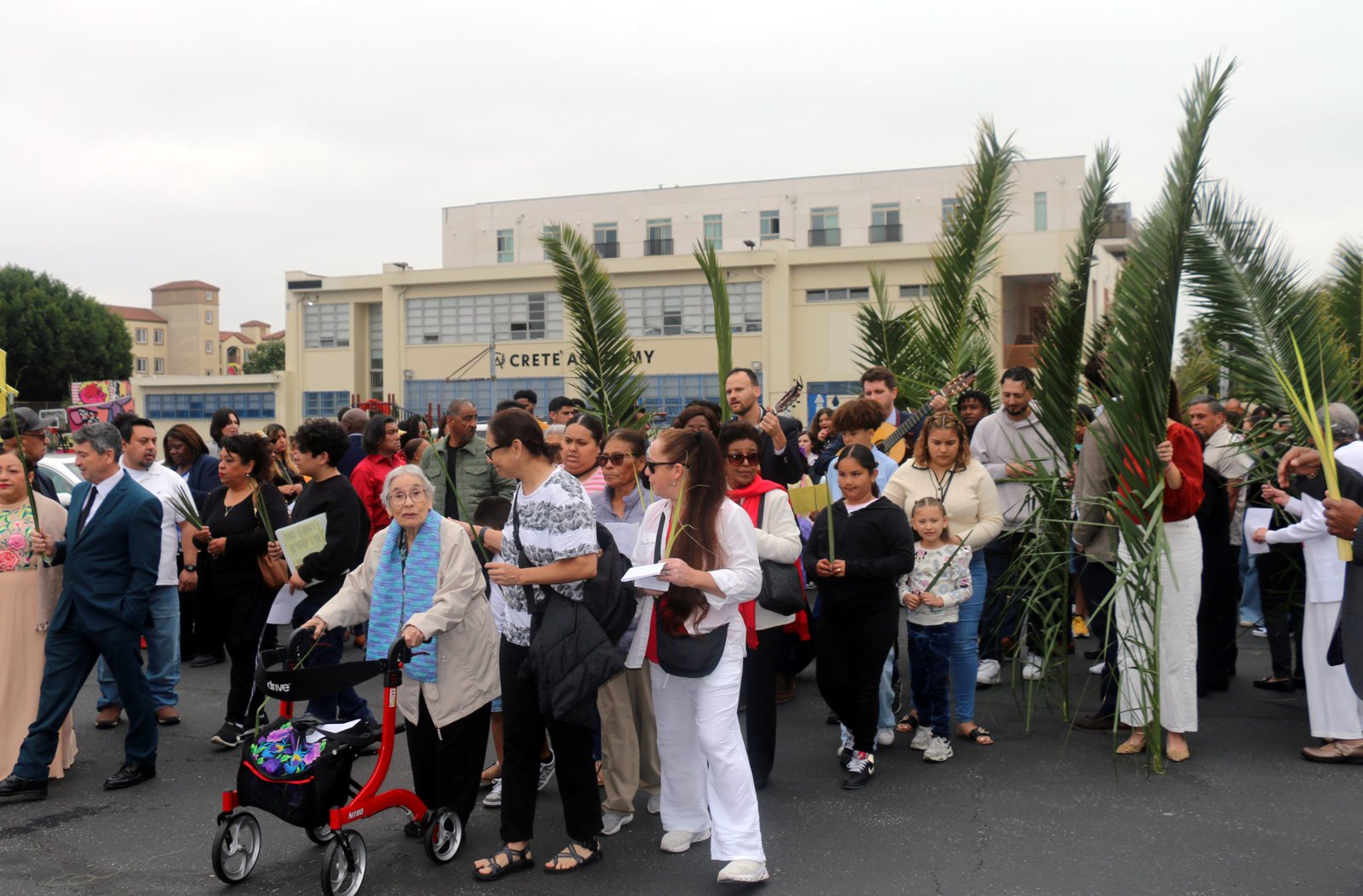 Parishioners at St. John the Evangelist Church in South LA lead a procession onto Crenshaw Boulevard during Palm Sunday on April 13. (Pablo Kay)