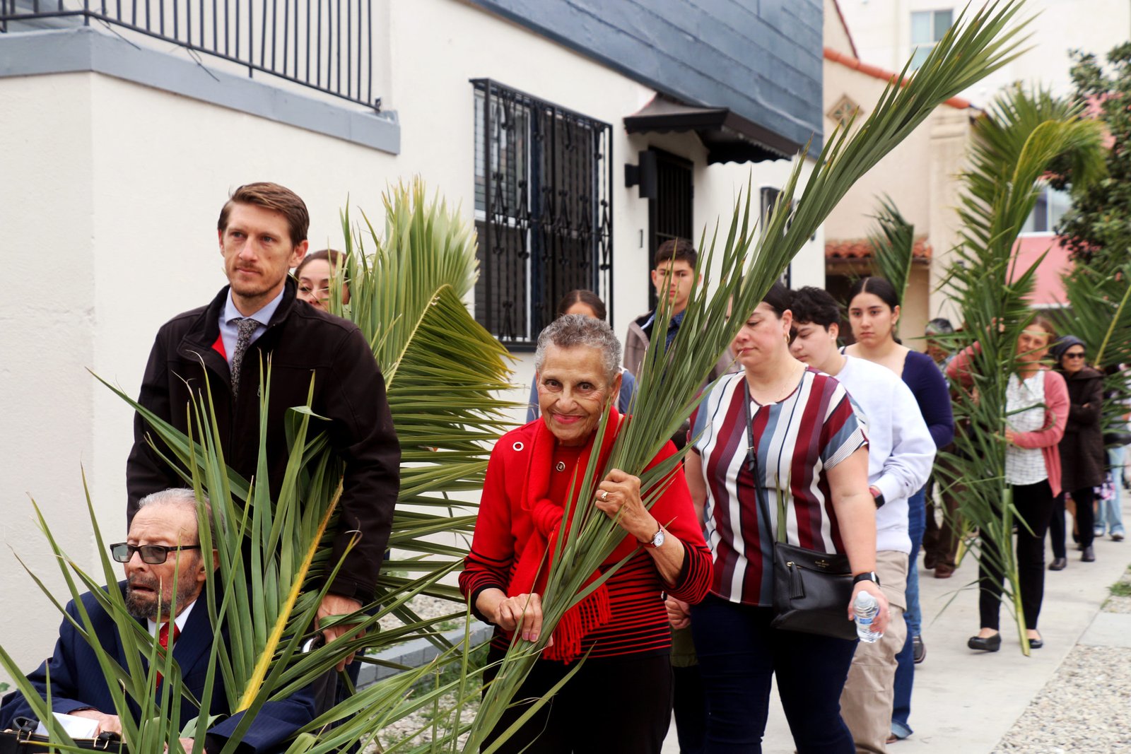 Parishioners at St. John the Evangelist Church in South LA lead a procession onto Crenshaw Boulevard during Palm Sunday on April 13. (Pablo Kay)