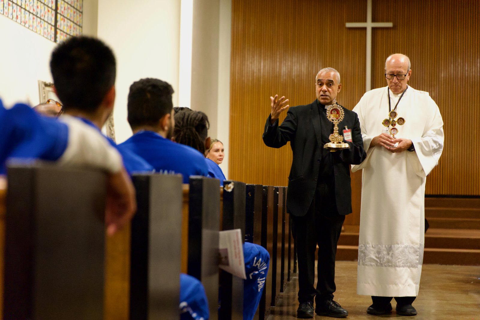 Msgr. Anthony Figueiredo, a priest in Assisi, Italy, speaks to inmates at LA Men’s Central Jail about the life of St. Carlo Acutis before Mass Oct. 20. At right is Deacon Fermin Lopez. (Reese Cuevas)