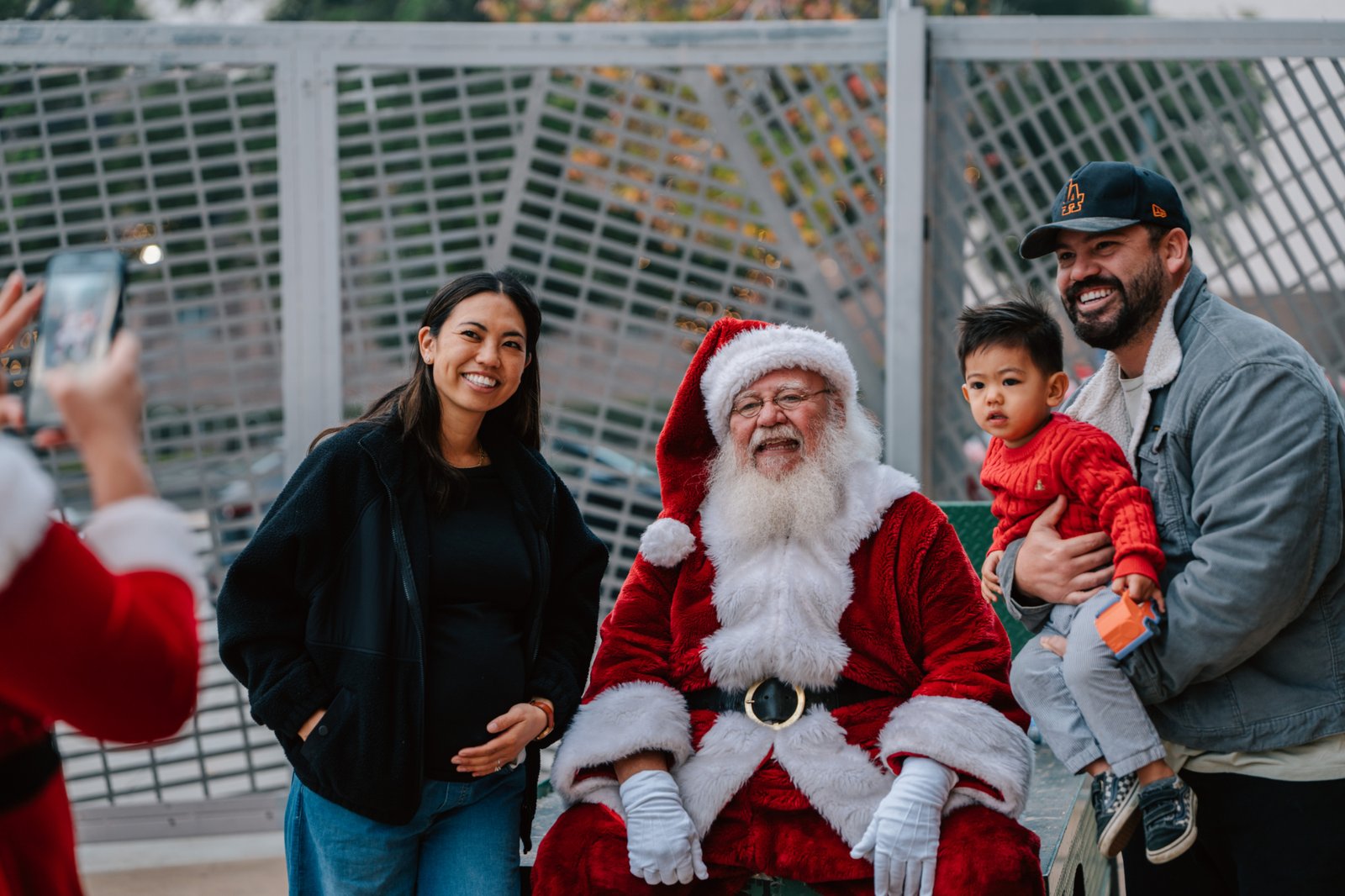 Volunteers pose for photos with Santa during the annual Adopt-a-Family LA gift distribution event on Dec. 13 at the Cathedral of Our Lady of the Angels. (Peter Lobato)