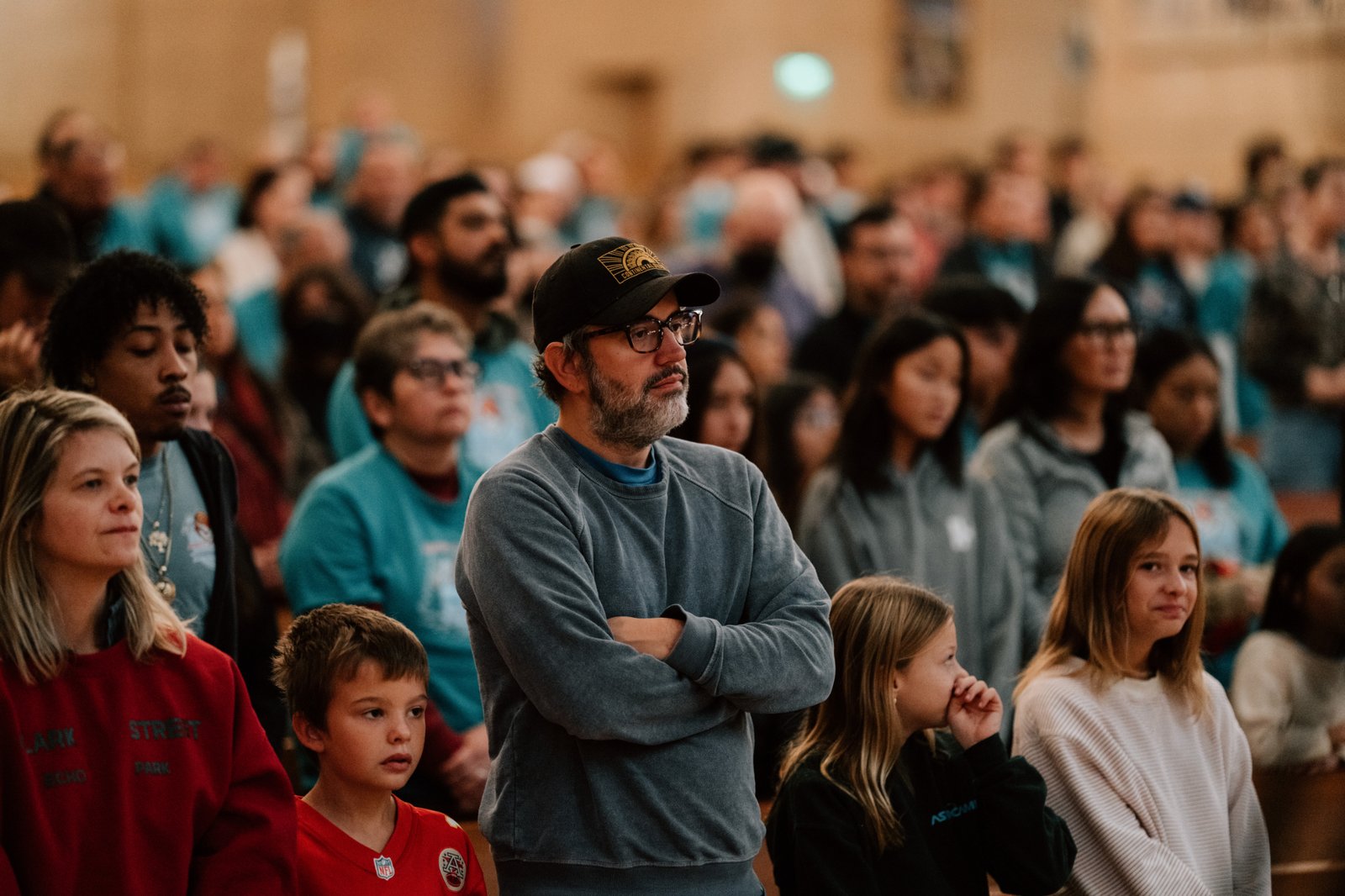 Volunteers pray inside the Cathedral of Our Lady of the Angels during the annual Adopt-a-Family LA distribution event on Dec. 13. (Peter Lobato)
