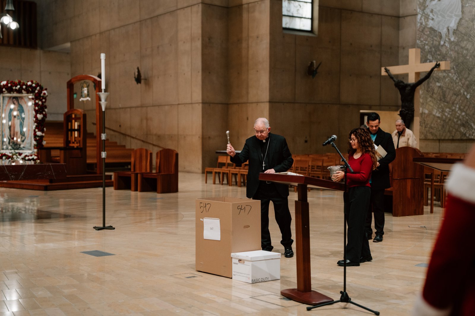 Archbishop José H. Gomez blesses one of the boxes containing toys, food, clothes, and household items being distributed to needy families during the Adopt-a-Family distribution event at the Cathedral of Our Lady of the Angels on Dec. 13. (Peter Lobato)