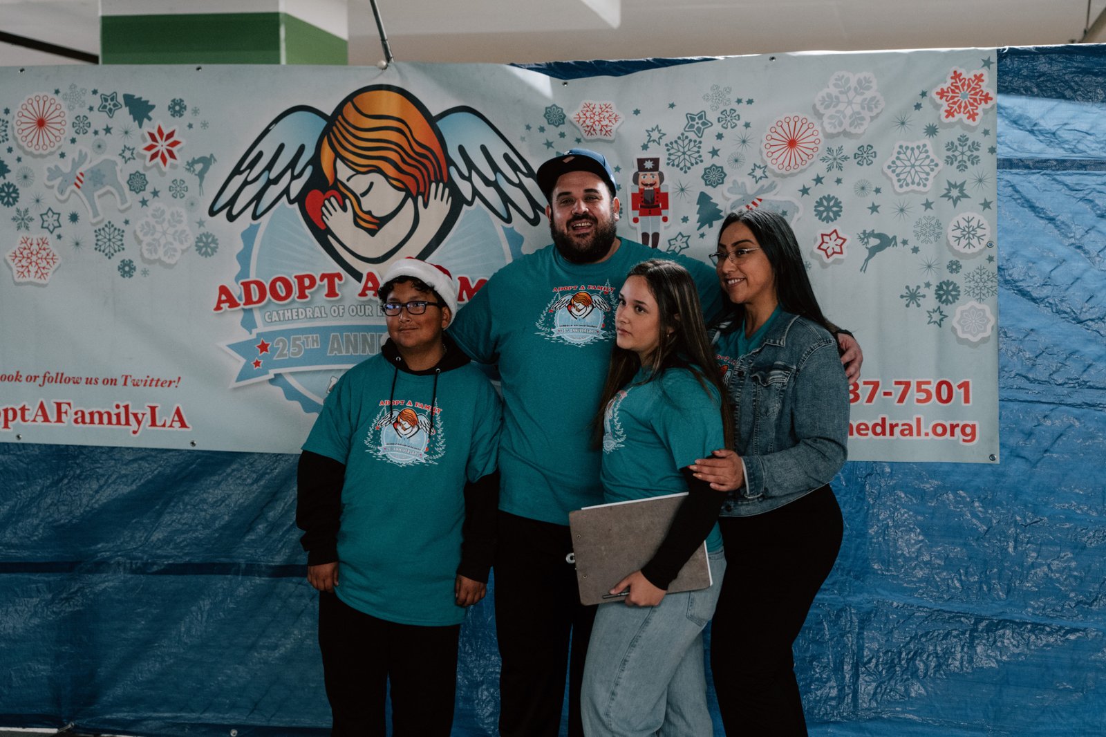 Volunteers pose for photos during the annual Adopt-a-Family LA gift distribution event on Dec. 13 at the Cathedral of Our Lady of the Angels. (Peter Lobato)