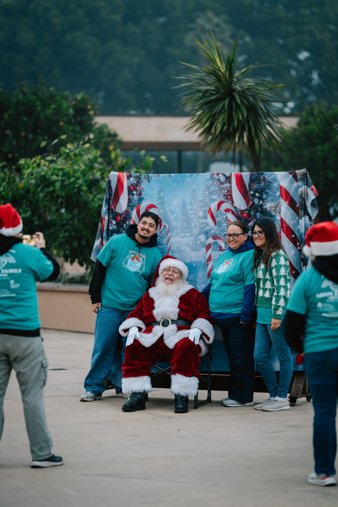 Volunteers pose for photos with Santa during the annual Adopt-a-Family LA gift distribution event on Dec. 13 at the Cathedral of Our Lady of the Angels. (Peter Lobato)