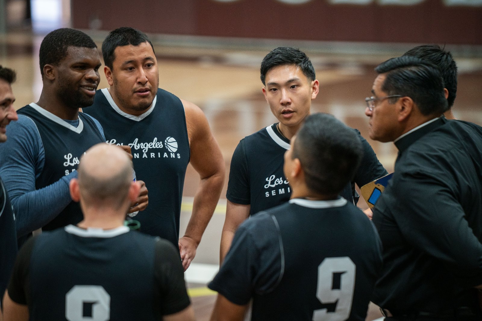 The LA seminarians huddle during a timeout while playing against the Capuchin Franciscans in the Archdiocese of Los Angeles' annual priests vs. seminarians basketball game, this year on Jan. 18 at St. Francis High School in La Cañada Flintridge. (John Rueda)