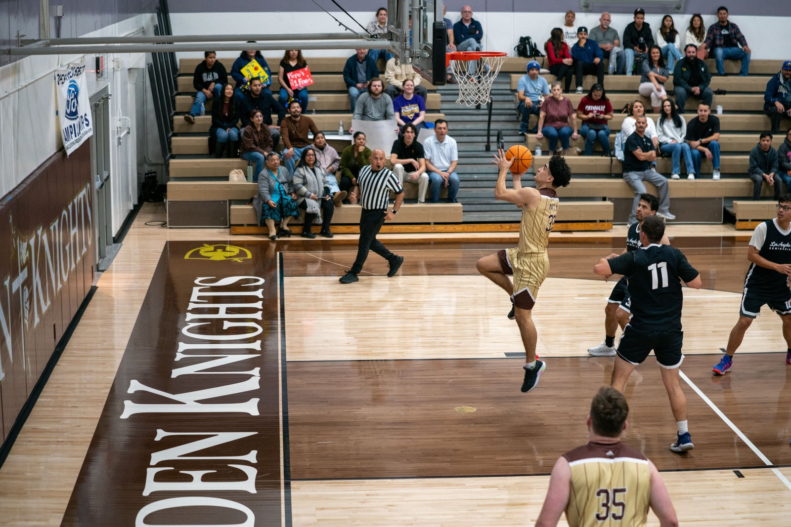 Game action as the Capuchin Franciscans play against the seminarians in the Archdiocese of Los Angeles' annual priests vs. seminarians basketball game, this year on Jan. 18 at St. Francis High School in La Cañada Flintridge. (John Rueda)