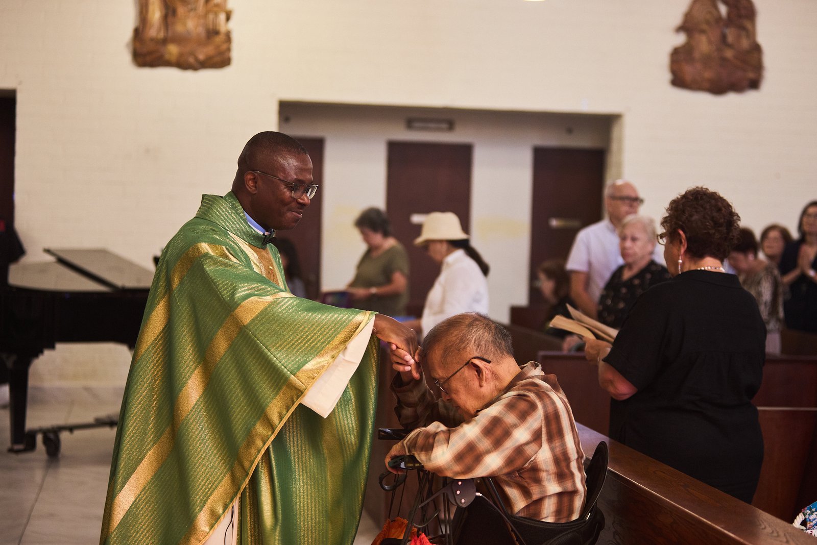 Father Chidi Ekpendu, pastor at St. Francis of Assisi Church in Silver Lake, blesses a parishioner during a special Mass on Oct. 4 in a weekend of special events marking the 800th anniversary of St. Francis’ death in 1226. (John Geronilla)