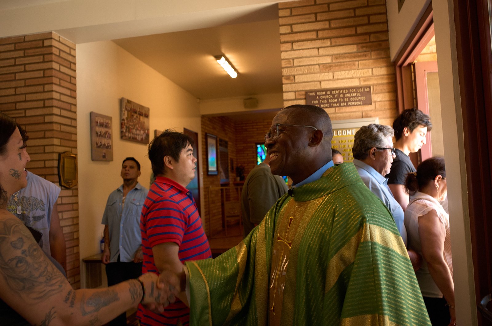 Father Chidi Ekpendu, pastor at St. Francis of Assisi Church in Silver Lake, greets parishioners following a special Mass on Oct. 4 in a weekend of special events marking the 800th anniversary of St. Francis’ death in 1226. (John Geronilla)