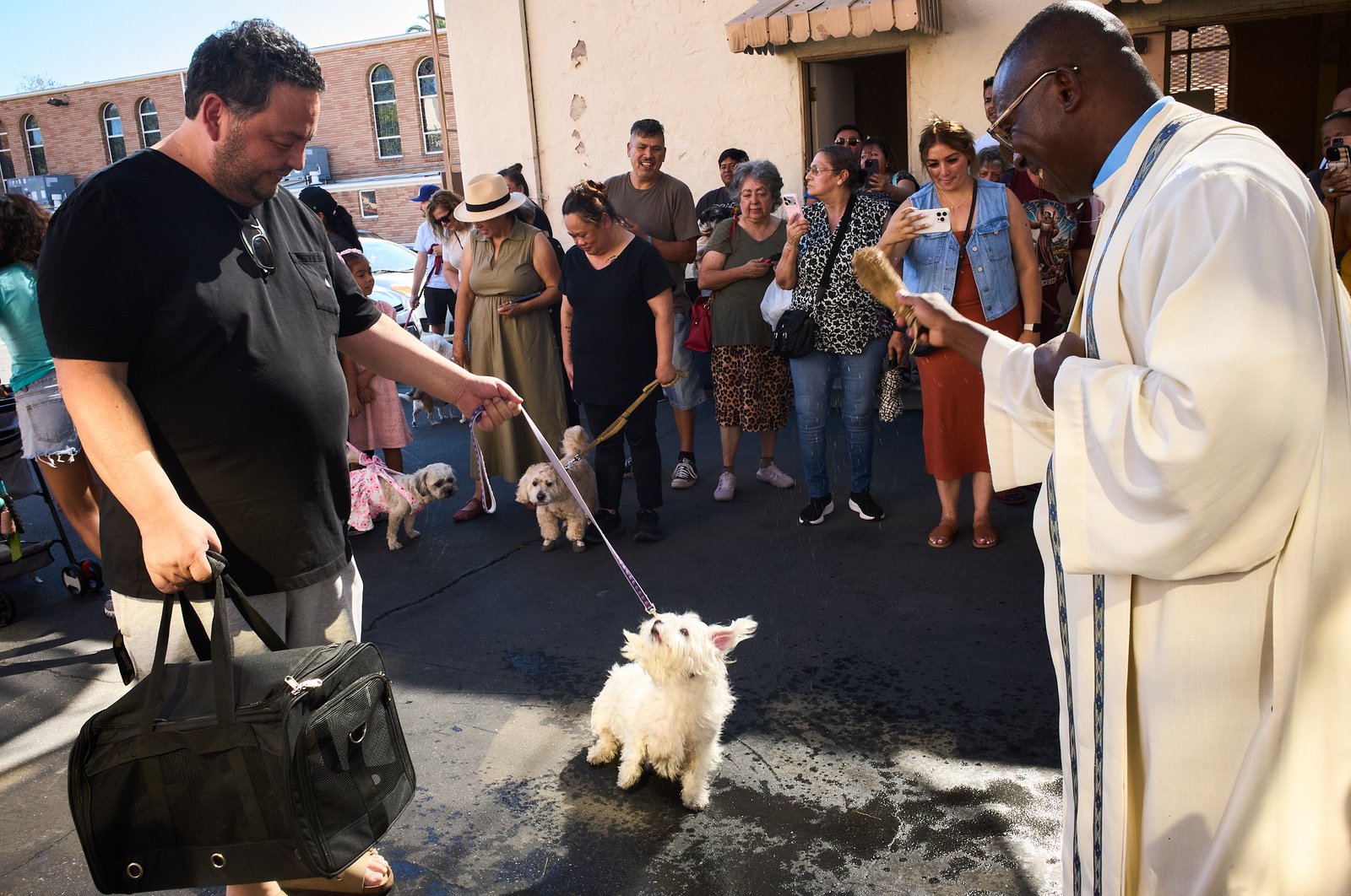 Father Chidi Ekpendu, pastor at St. Francis of Assisi Church in Silver Lake, celebrates the parish patron’s feast day with a special “Blessing of the Animals” after a special Mass and parish potluck on Oct. 4. (John Geronilla)