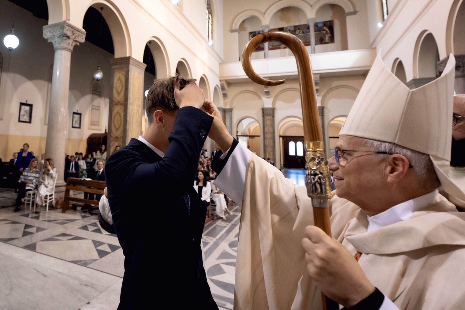 El entonces cardenal Robert Prevost administra el sacramento de la confirmación a un joven en San Patricio de Roma en mayo de 2024. (Escuela Internacional Marymount/Parroquia Católica Americana de San Patricio)