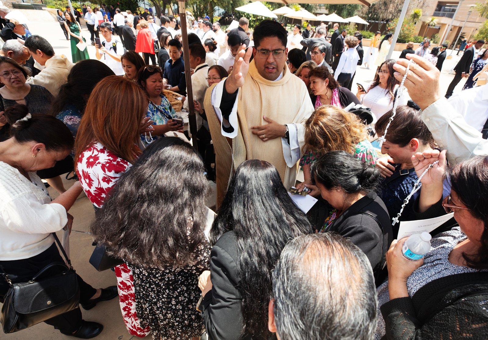 El Padre Jorge Moncada bendice a un grupo de seres queridos y simpatizantes después de la Misa de ordenación en la Catedral de Nuestra Señora de los Ángeles el 31 de mayo. (Víctor Alemán)
