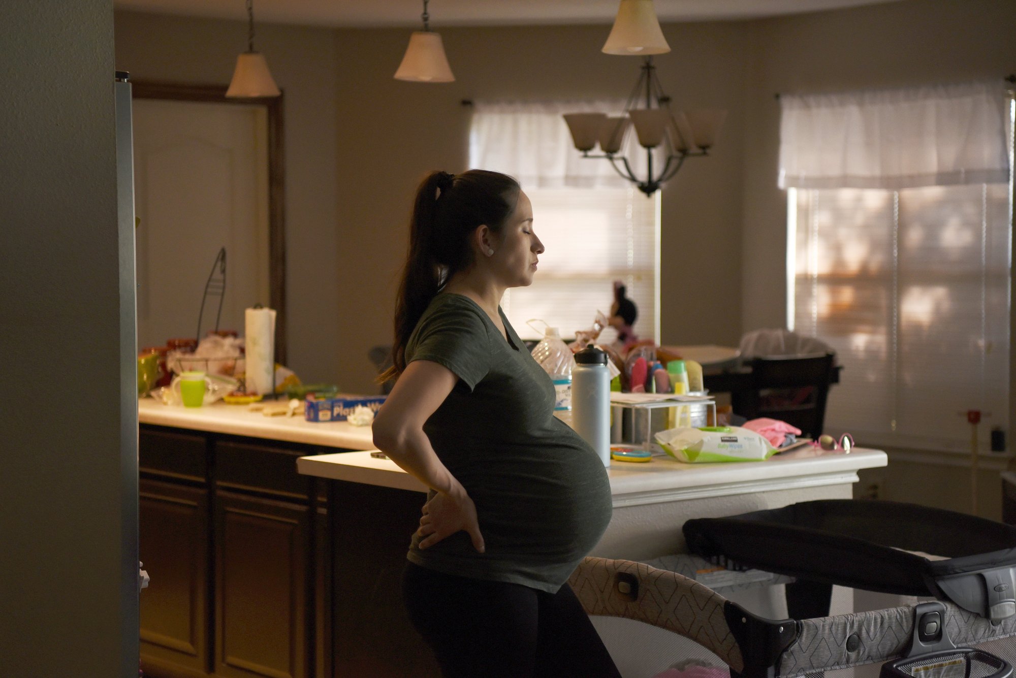 A pregnant woman at her home