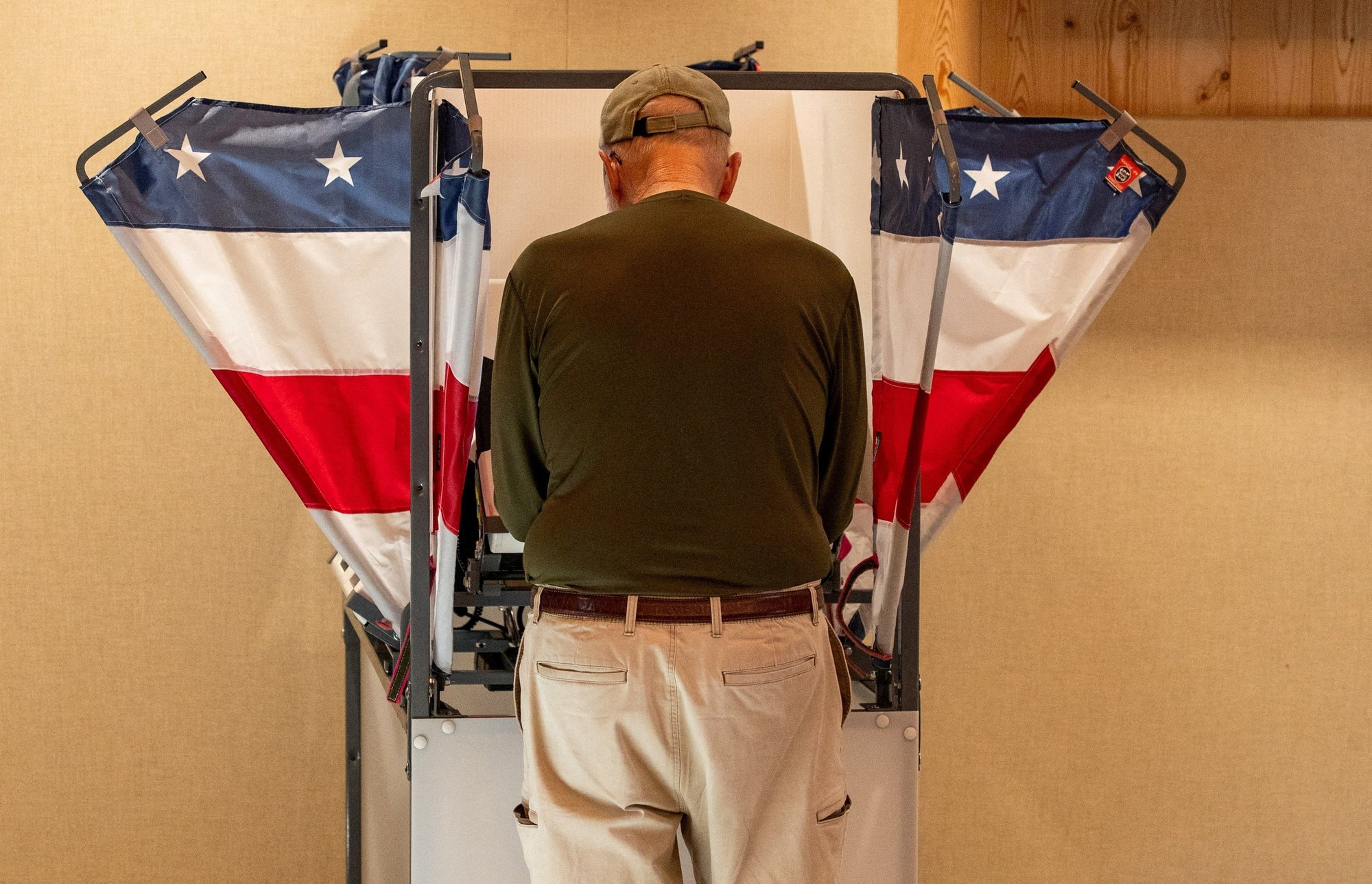 A person votes at a polling station