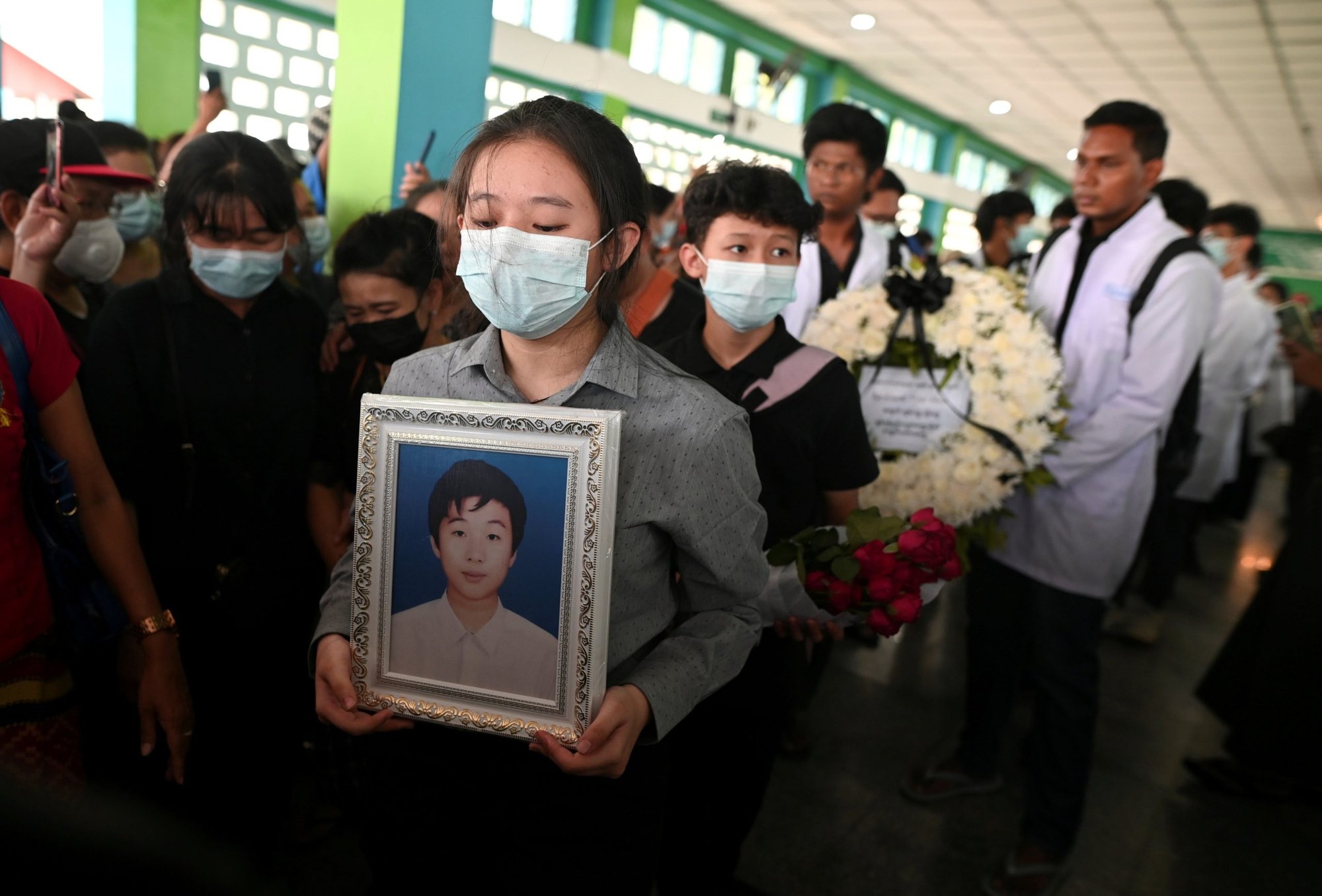 Una mujer marcha con una foto de Khant Nyar Hein, un estudiante de medicina de 17 aos que fue asesinado a tiros durante la represin de las fuerzas de seguridad contra los manifestantes antigolpistas, durante su funeral en Yangon, Myanmar, el 16 de marzo de 2021. El papa Francisco pidi el 17 de marzo un fin de la violencia y que comience el dialogo en Myanmar, donde las fuerzas de seguridad han matado al menos a 138 personas desde el 1 de febrero. (Foto CNS / Reuters)