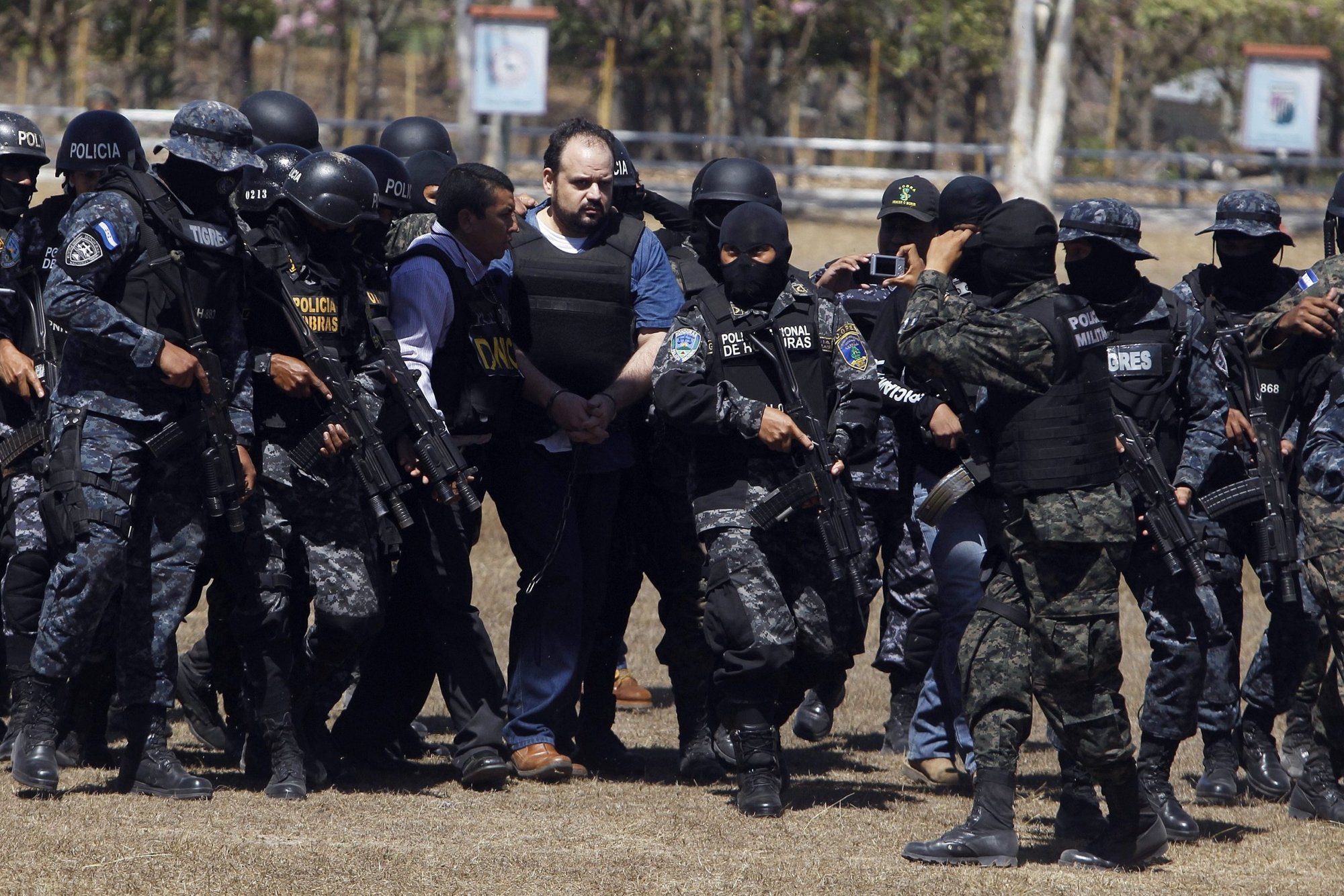 Fuerzas especiales hondureñas escoltan al político y presunto narcotraficante José Miguel Handal a un batallón militar en Tegucigalpa el 13 de marzo de 2015. Los obispos de Honduras han instado a votantes que no apoyen a los candidatos "manchados" por los cárteles de la droga en las elecciones de noviembre. (Foto CNS/Jorge Cabrera, Reuters)