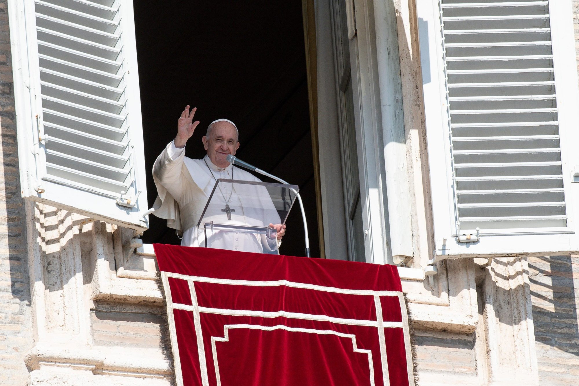 El papa Francisco saluda a la multitud mientras reza el Ángelus desde la ventana de su estudio con vista a la Plaza de San Pedro en el Vaticano el 17 de octubre de 2021. (Foto CNS/Vatican Media)