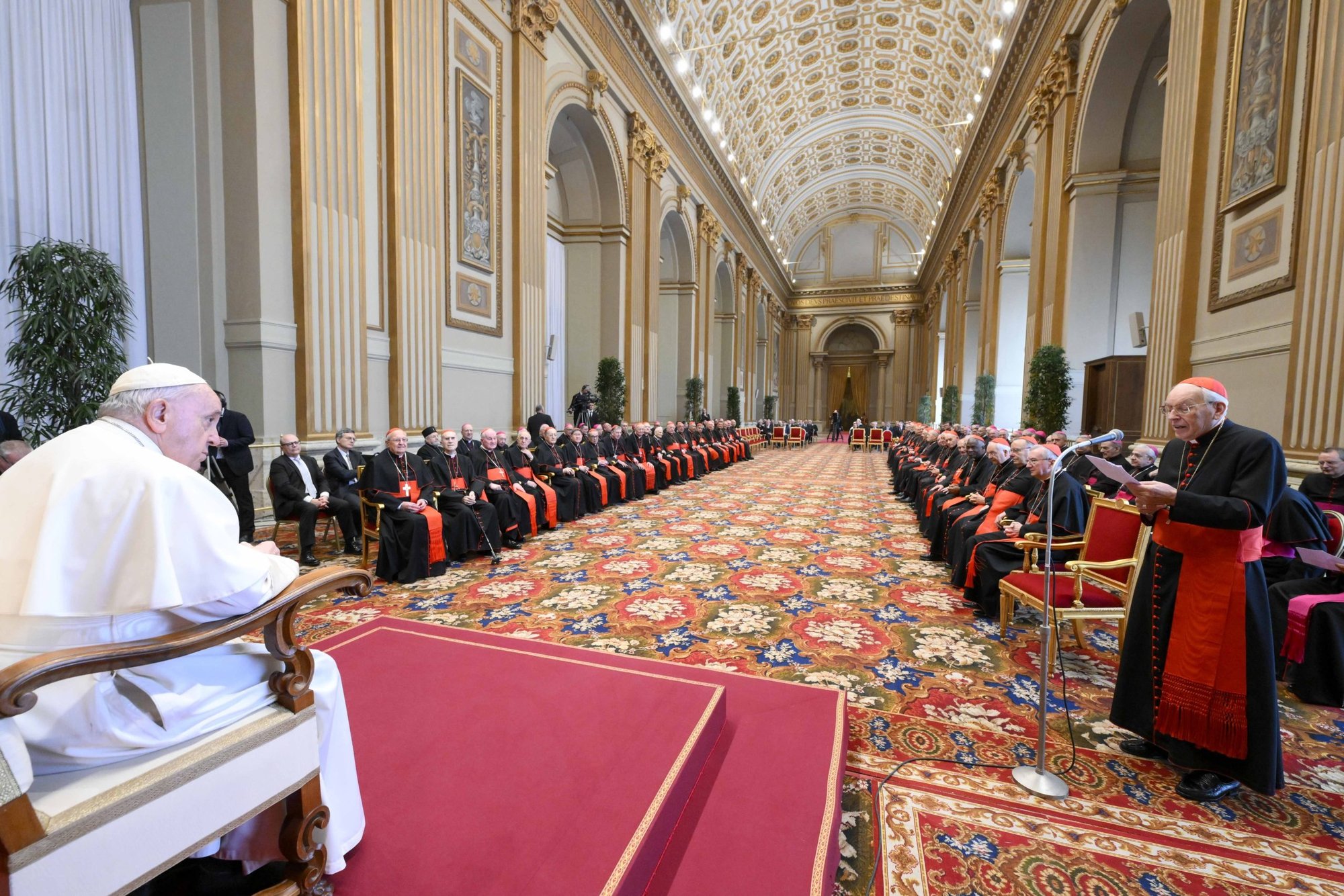 El papa Francisco escucha mientras el Cardenal Giovanni Battista Re, decano del Colegio Cardenalicio, ofrece saludos de Navidad en nombre de los cardenales y altos funcionarios de la Curia Romana durante una reunión el 22 de diciembre de 2022 en el Salón de Bendiciones del Vaticano. (Foto CNS/Vatican Media)